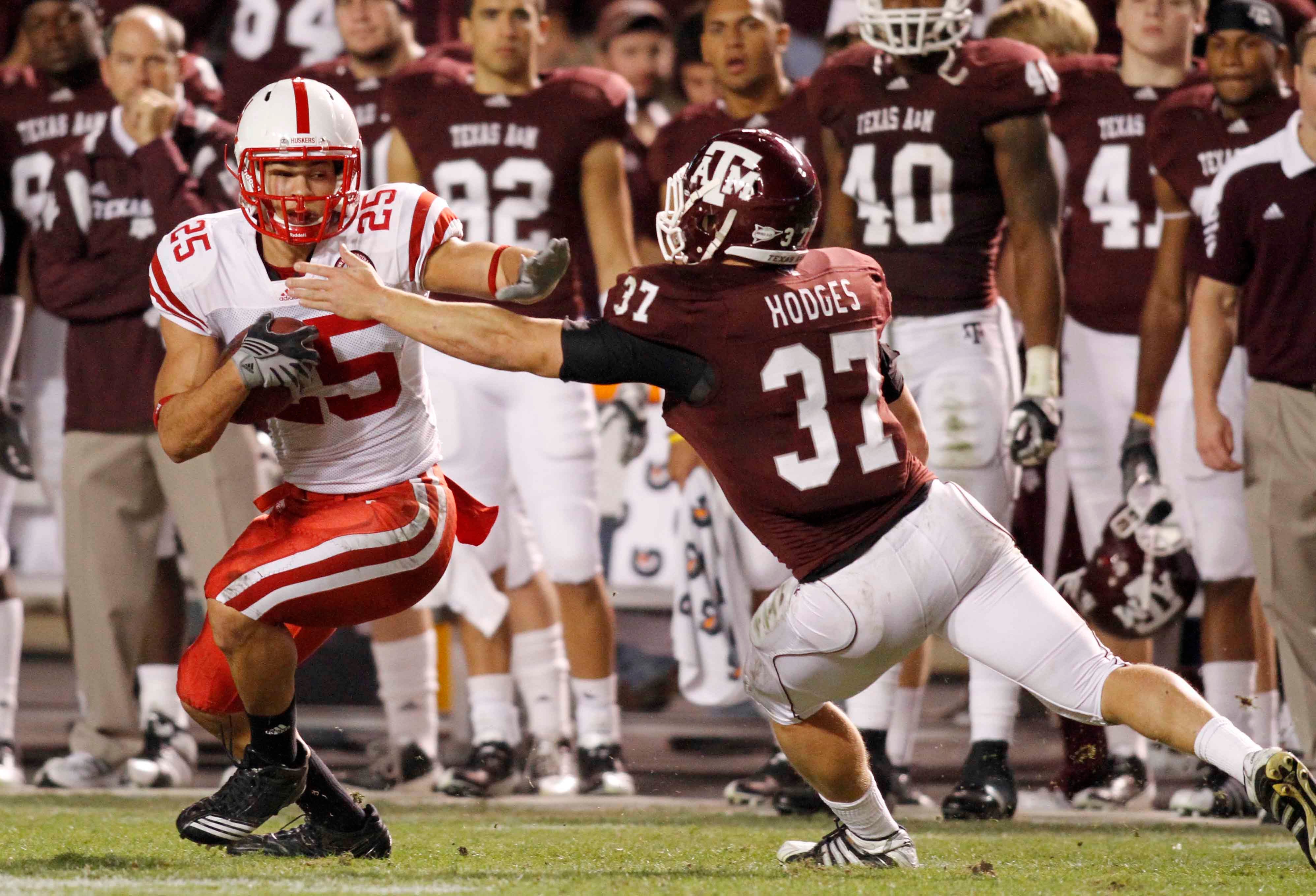 Nov 20, 2010; Houston, TX, USA; Nebraska Cornhuskers tight end Kyler Reed (25) is tackled by Texas A&M Aggies linebacker Michael Hodges (37) in the second quarter at Kyle Field.