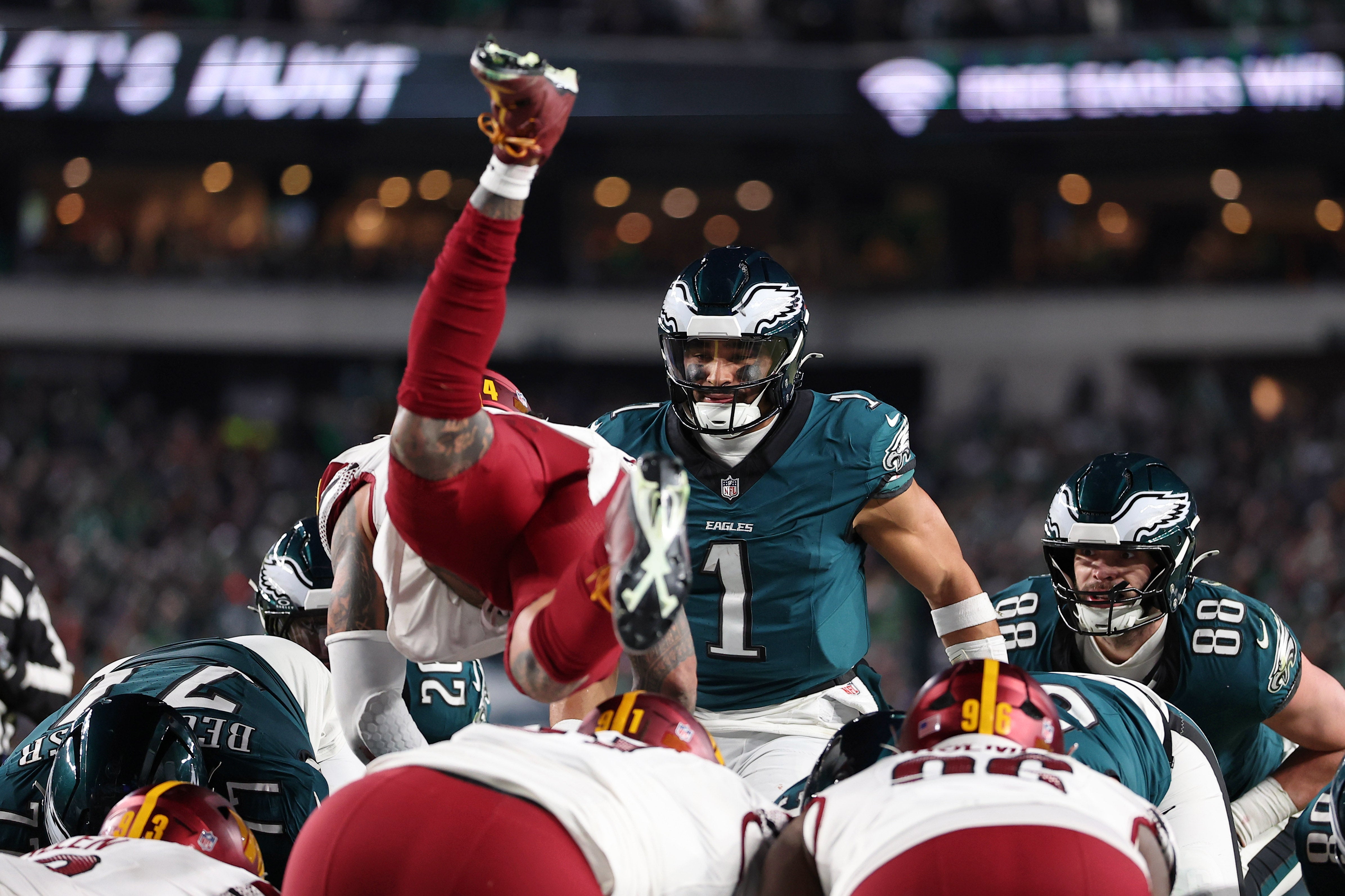 Philadelphia Eagles quarterback Jalen Hurts (1) reacts as Washington Commanders linebacker Frankie Luvu (4) leaps over linemen before a snap during the second half in the NFC Championship game at Lincoln.