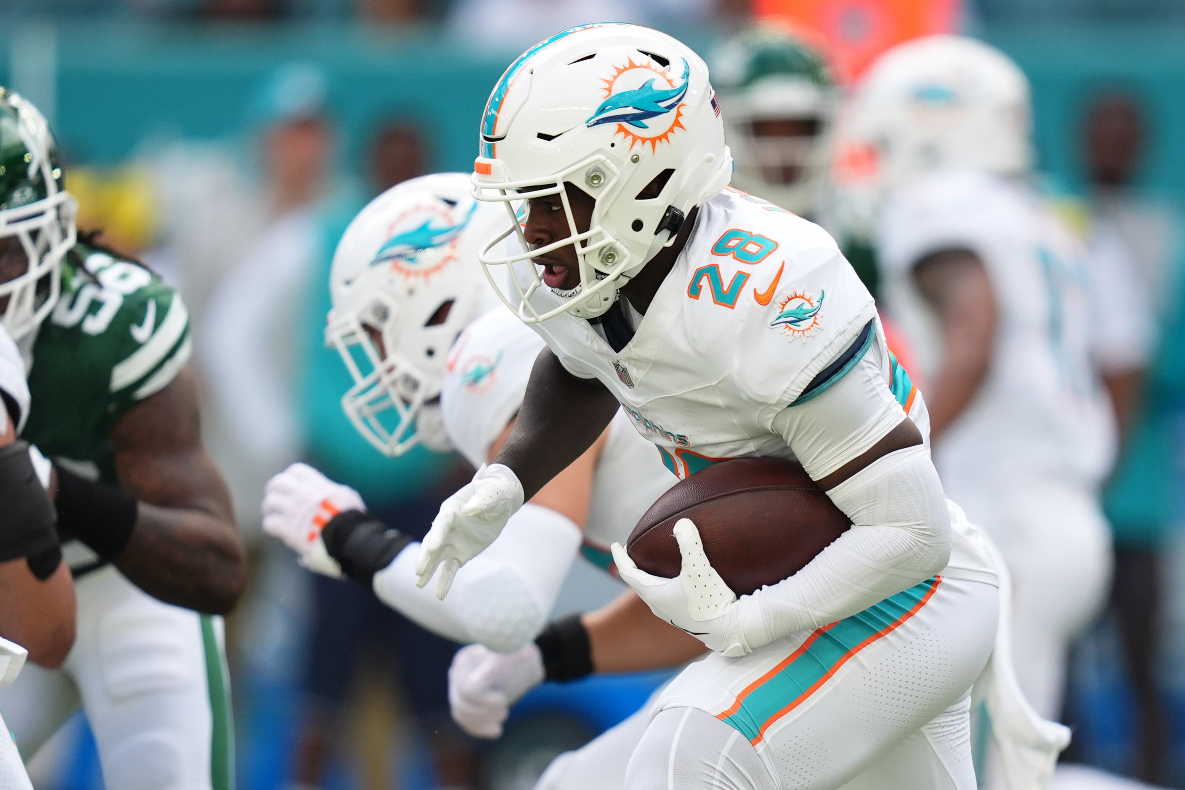 Dec 8, 2024; Miami Gardens, Florida, USA; Miami Dolphins running back De'Von Achane (28) runs the ball against the New York Jets during the first half at Hard Rock Stadium.