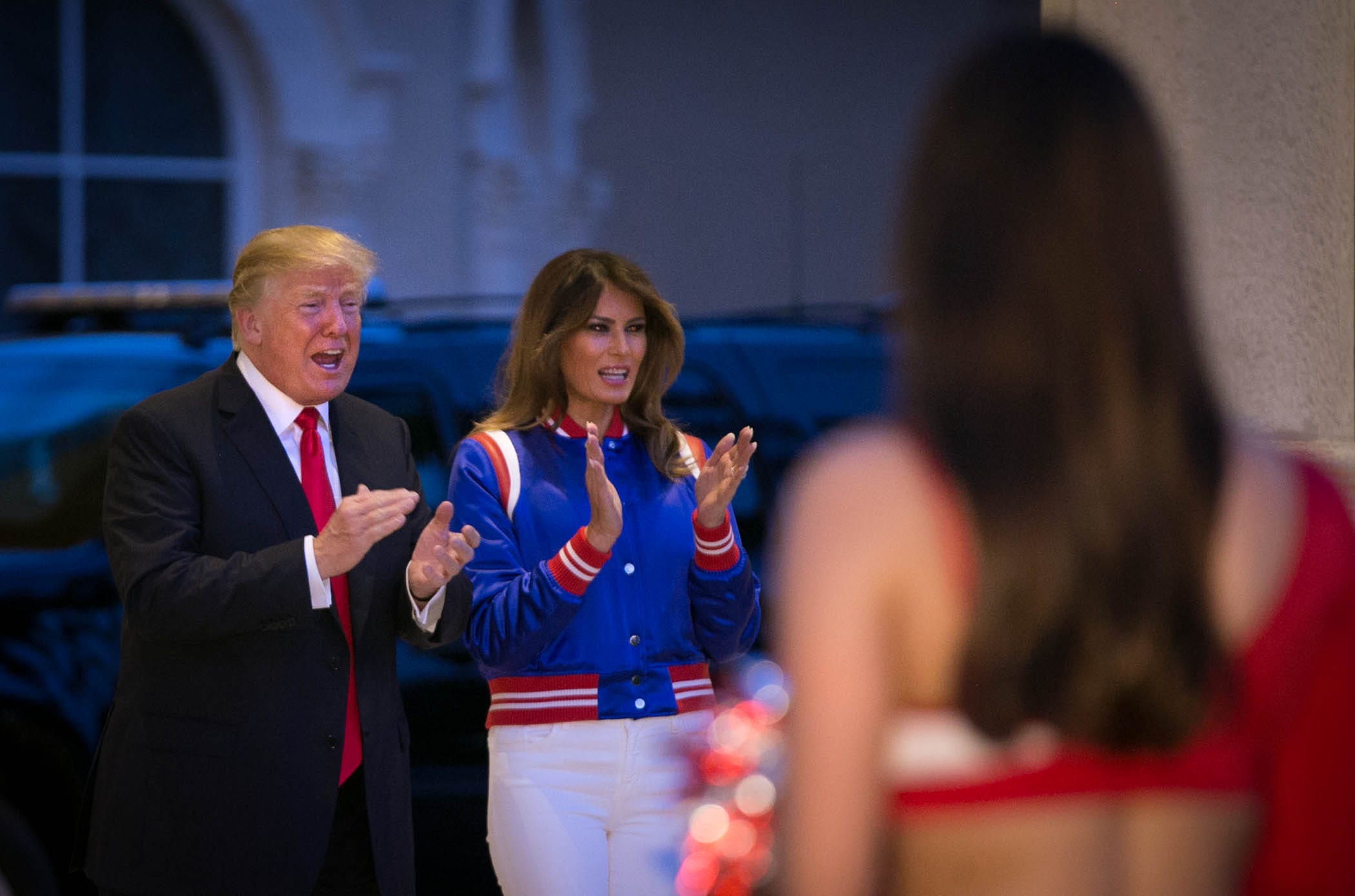 President Donald J. Trump and first lady, Melania, applaud the Florida Atlantic University Pep Band on the lawn of Trump International Golf Club before attending the President's annual Super Bowl watch party at the club in West Palm Beach, Florida on February 2, 2018.  