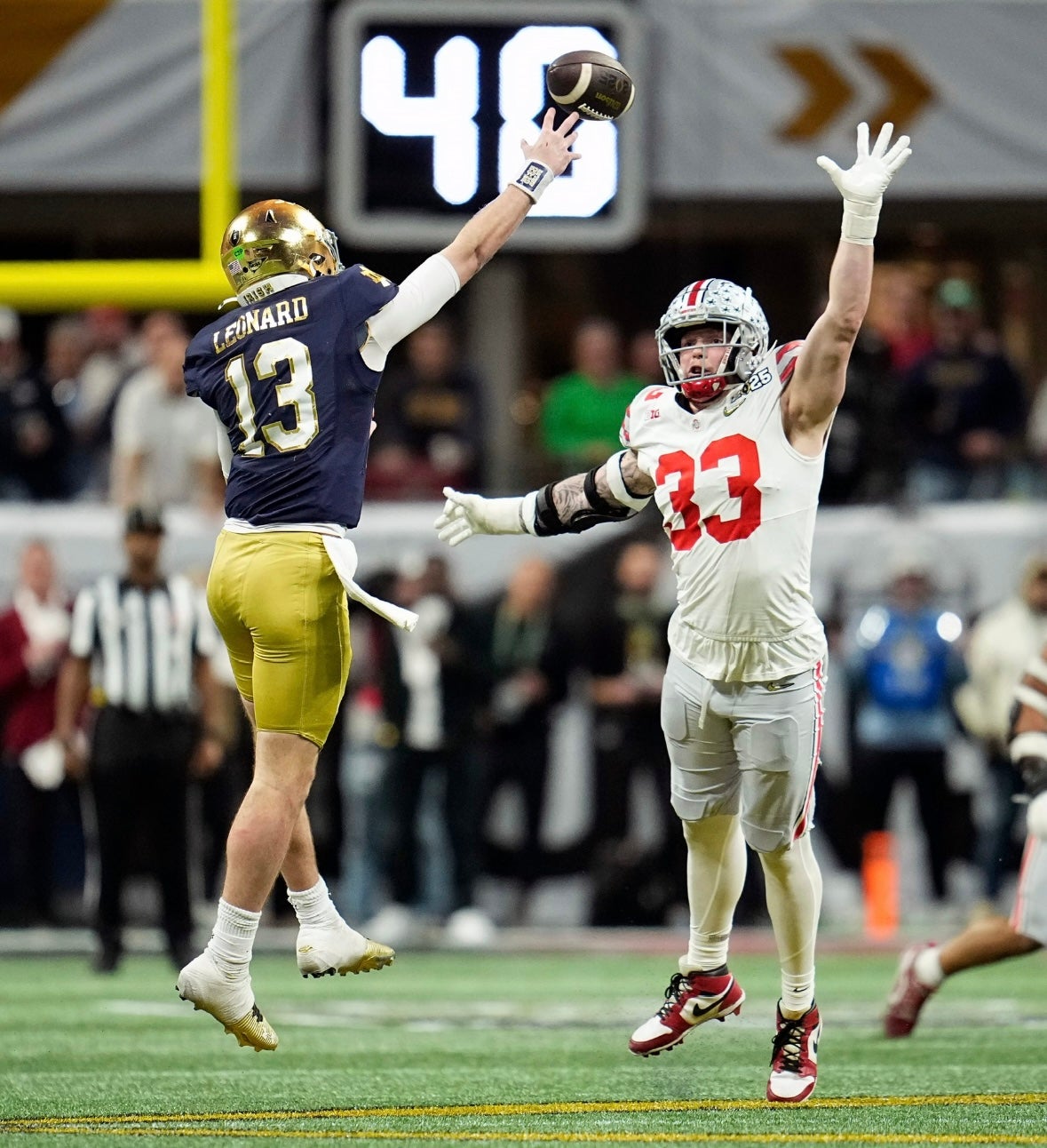 Ohio State Buckeyes defensive end Jack Sawyer (33) tries to get the pass thrown by Notre Dame Fighting Irish quarterback Riley Leonard (13) in the fourth quarter during the College Football Playoff National Championship at Mercedes-Benz Stadium in Atlanta on January 20, 2025.