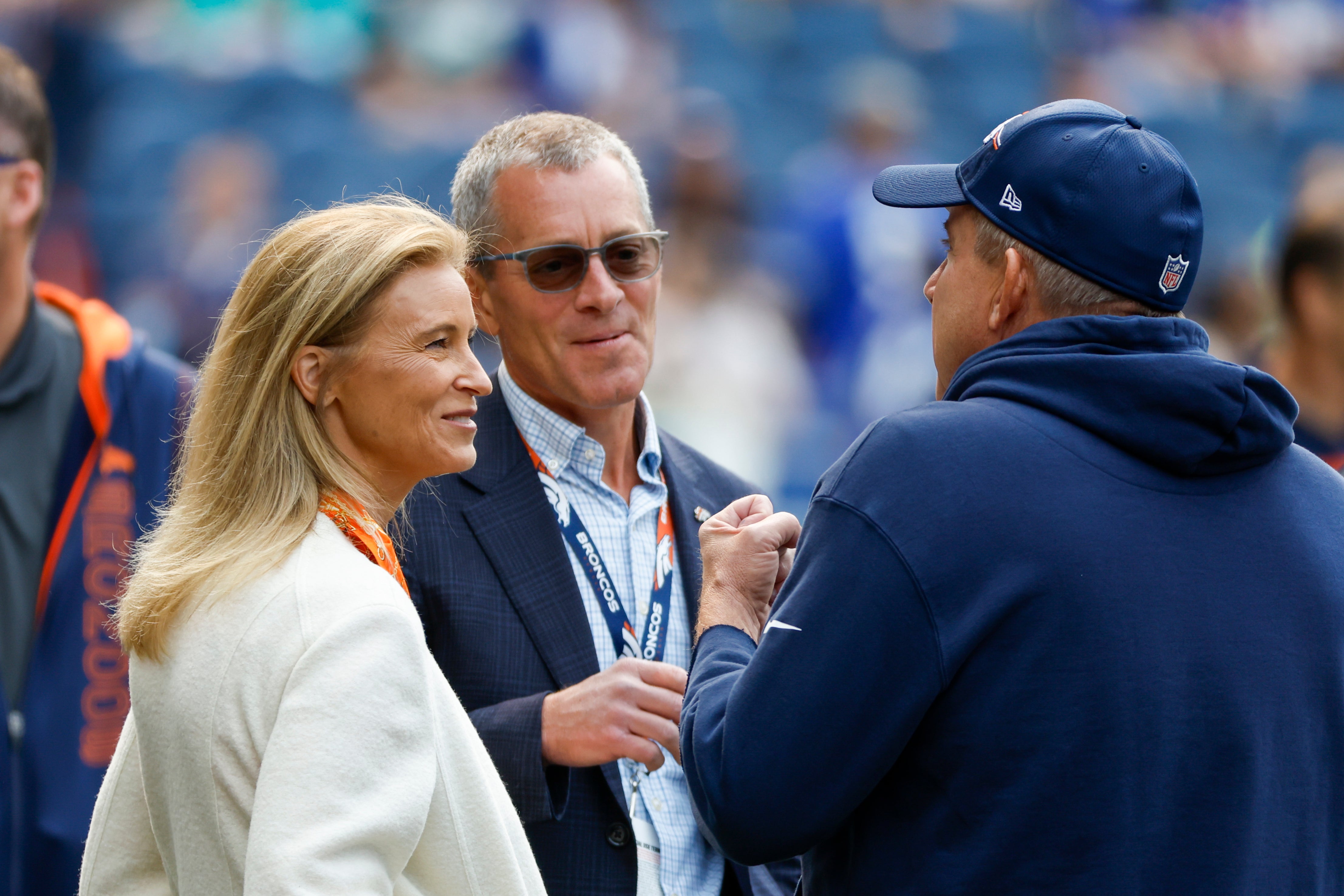 Sep 8, 2024; Seattle, Washington, USA; Denver Broncos owners Carrie Walton Penner, left, and Greg Penner talk with head coach Sean Payton during pregame warmups against the Seattle Seahawks at Lumen Field.