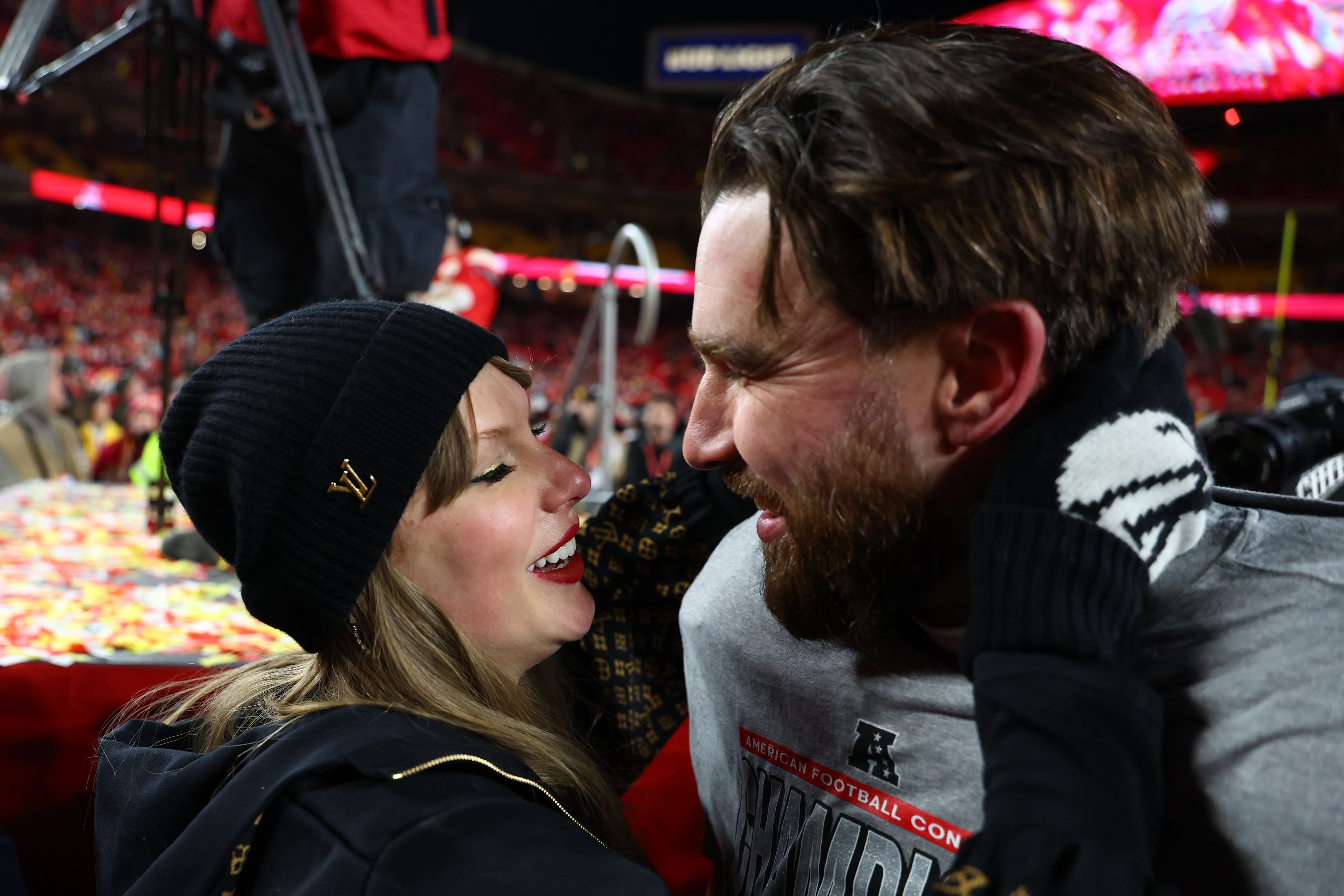 Jan 26, 2025; Kansas City, MO, USA; Recording artist Taylor Swift and Kansas City Chiefs tight end Travis Kelce (87) react after the AFC Championship game against the Buffalo Bills at GEHA Field at Arrowhead Stadium