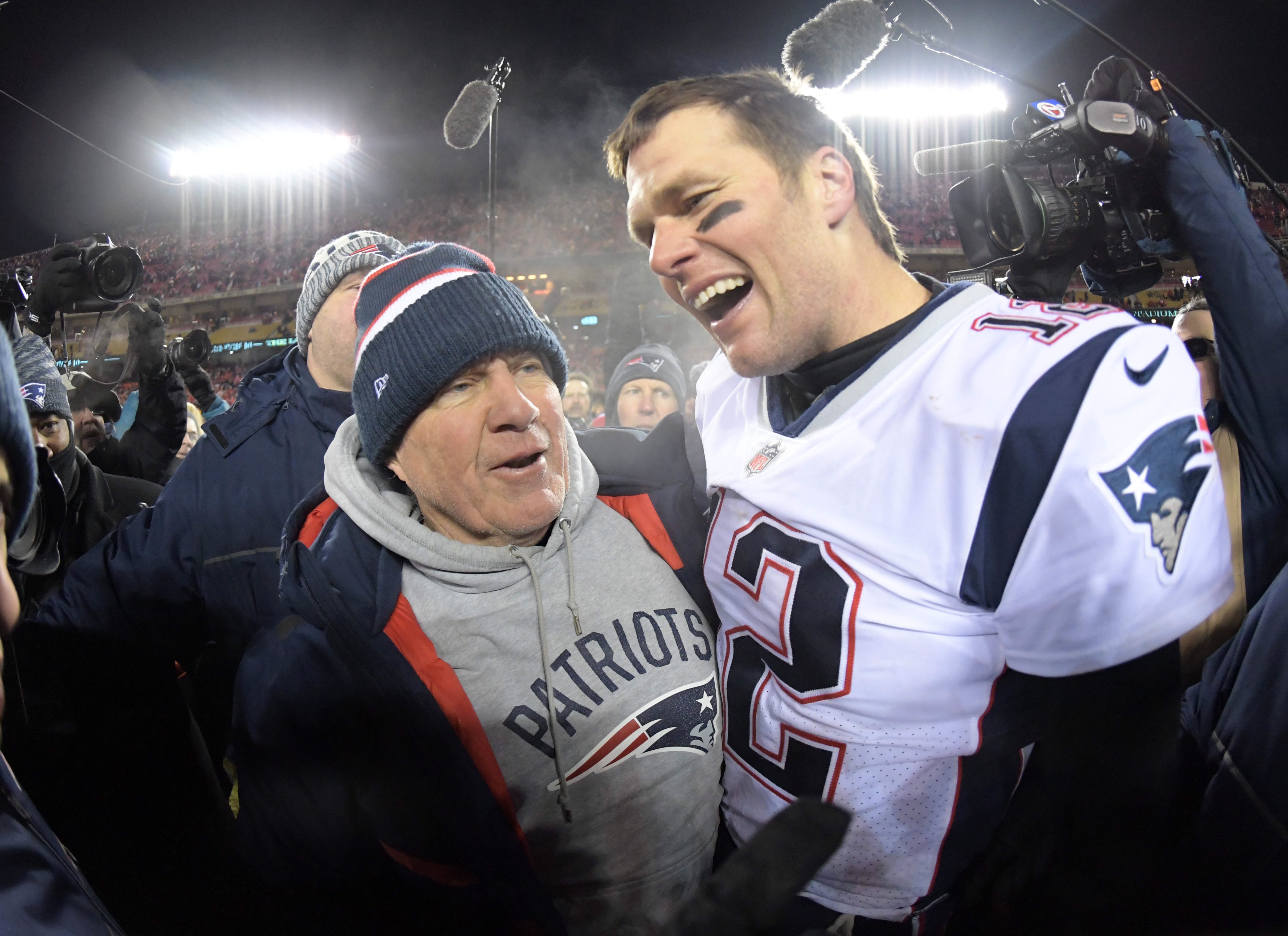 New England Patriots quarterback Tom Brady (12) celebrates with coach Bill Belichick after the AFC Championship game against the Kansas City Chiefs at Arrowhead Stadium. The Patriots defeated the Chiefs 37-31 in overtime to advance to fifth Super Bowl in eight seasons.