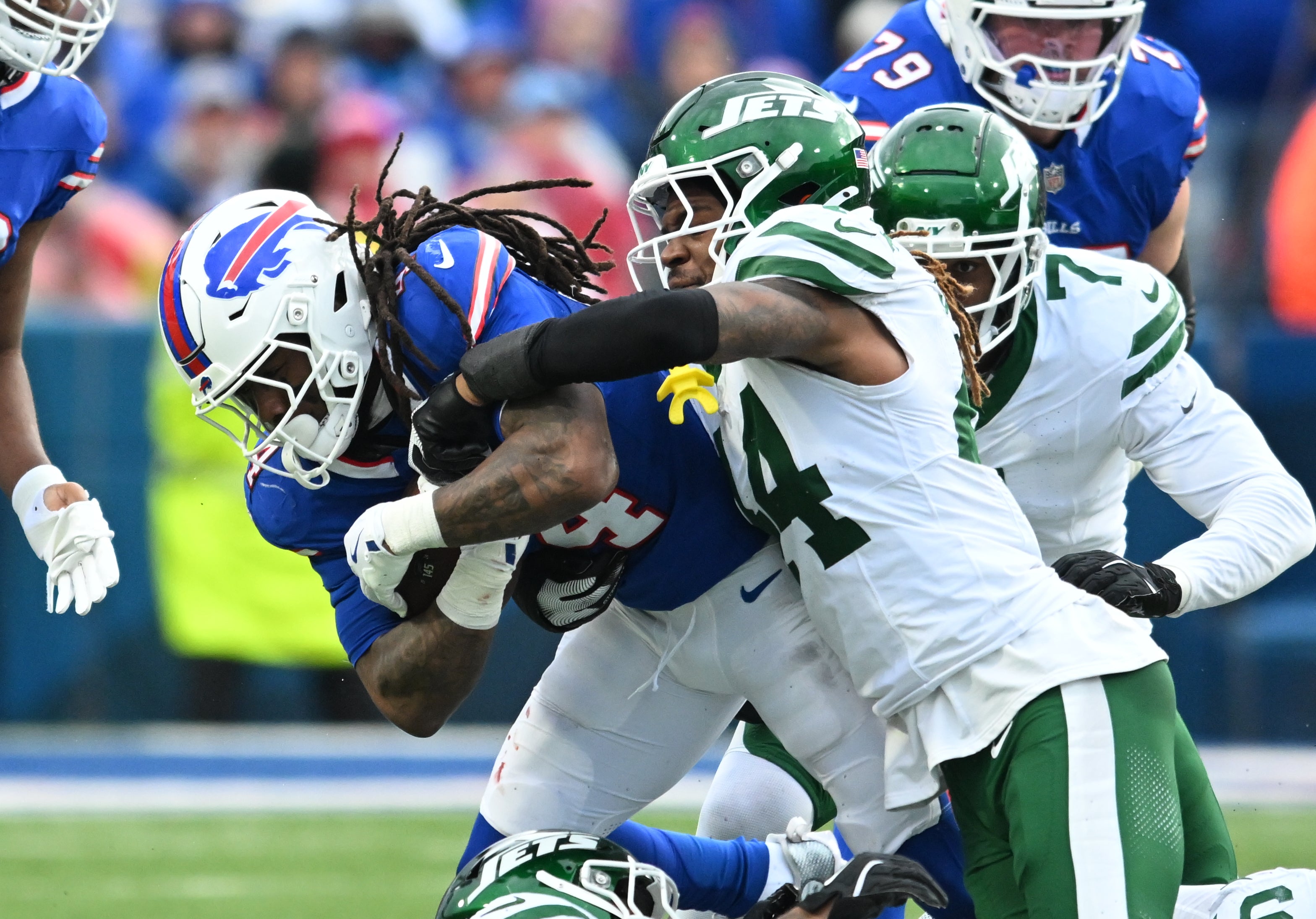 New York Jets linebacker Jamien Sherwood (44) makes a tackle on Buffalo Bills running back James Cook (4) in the second quarter at Highmark Stadium.
