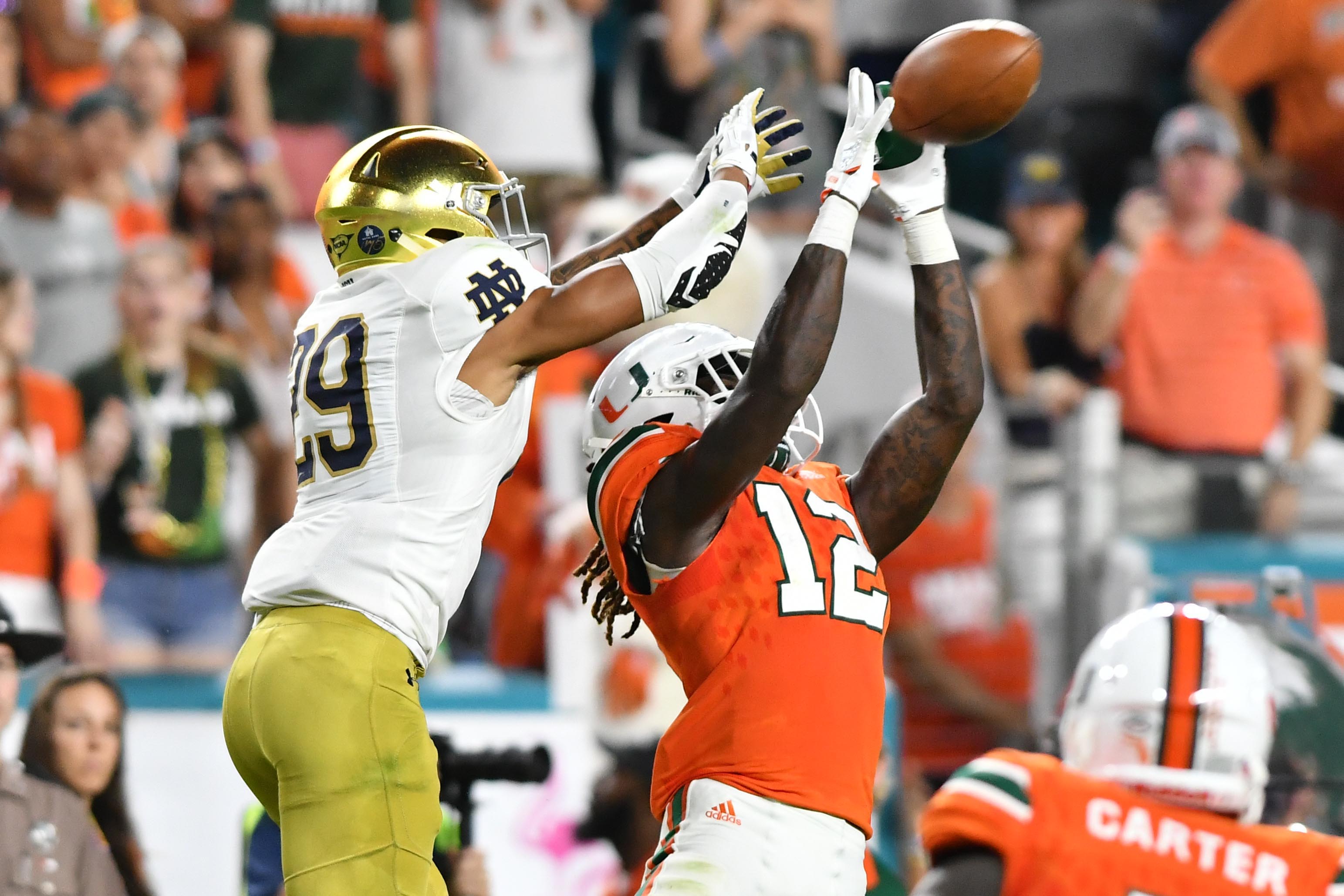 Nov 11, 2017; Miami Gardens, FL, USA; Miami Hurricanes cornerback Malek Young (12) breaks up a pass intended for Notre Dame Fighting Irish wide receiver Kevin Stepherson (29) in the second quarter at Hard Rock Stadium.