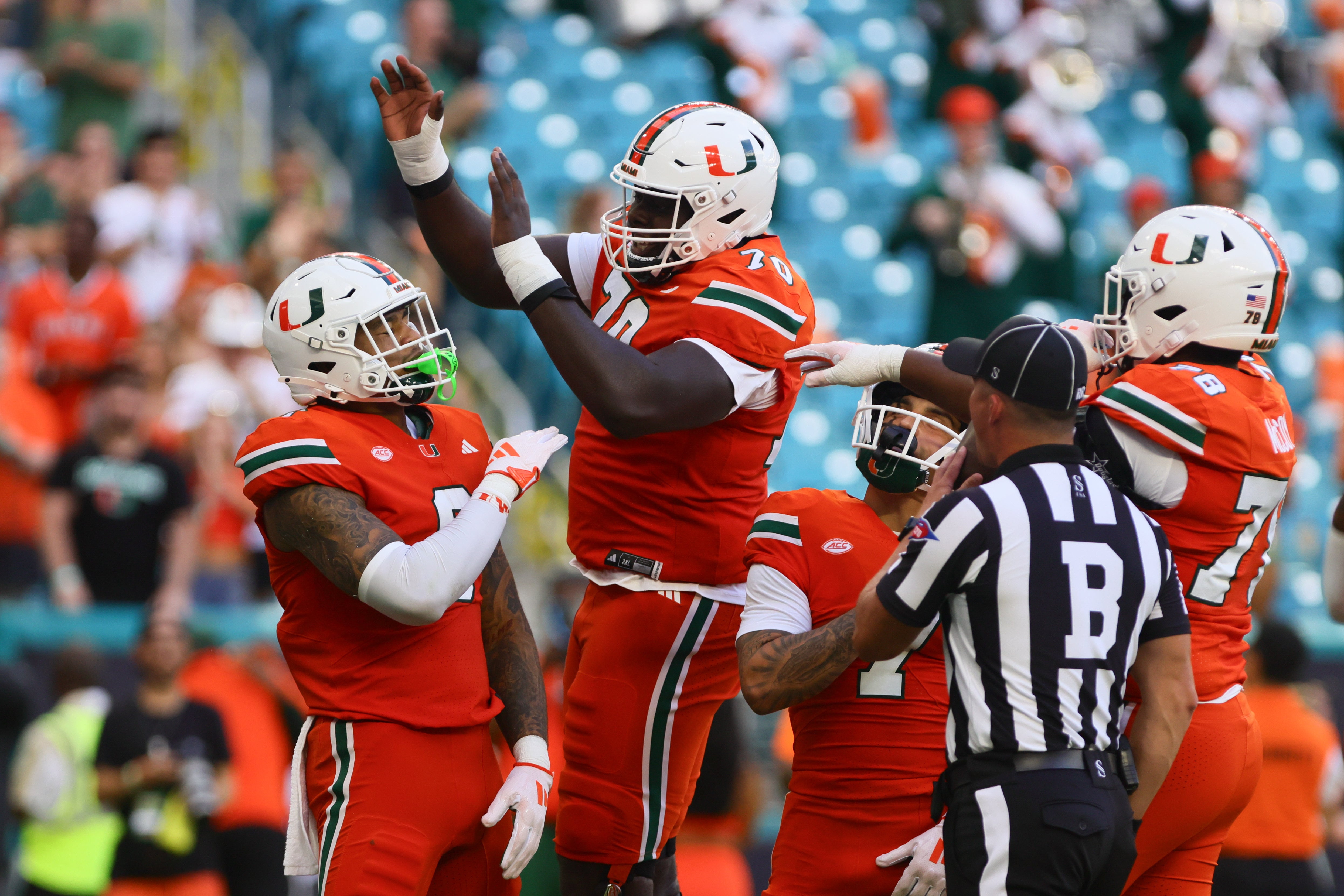 Sep 7, 2024; Miami Gardens, Florida, USA; Miami Hurricanes tight end Elijah Arroyo (8) celebrates with Miami Hurricanes offensive lineman Markel Bell (70) after scoring a touchdown against Florida A&M Rattlers during the first quarter at Hard Rock Stadium.