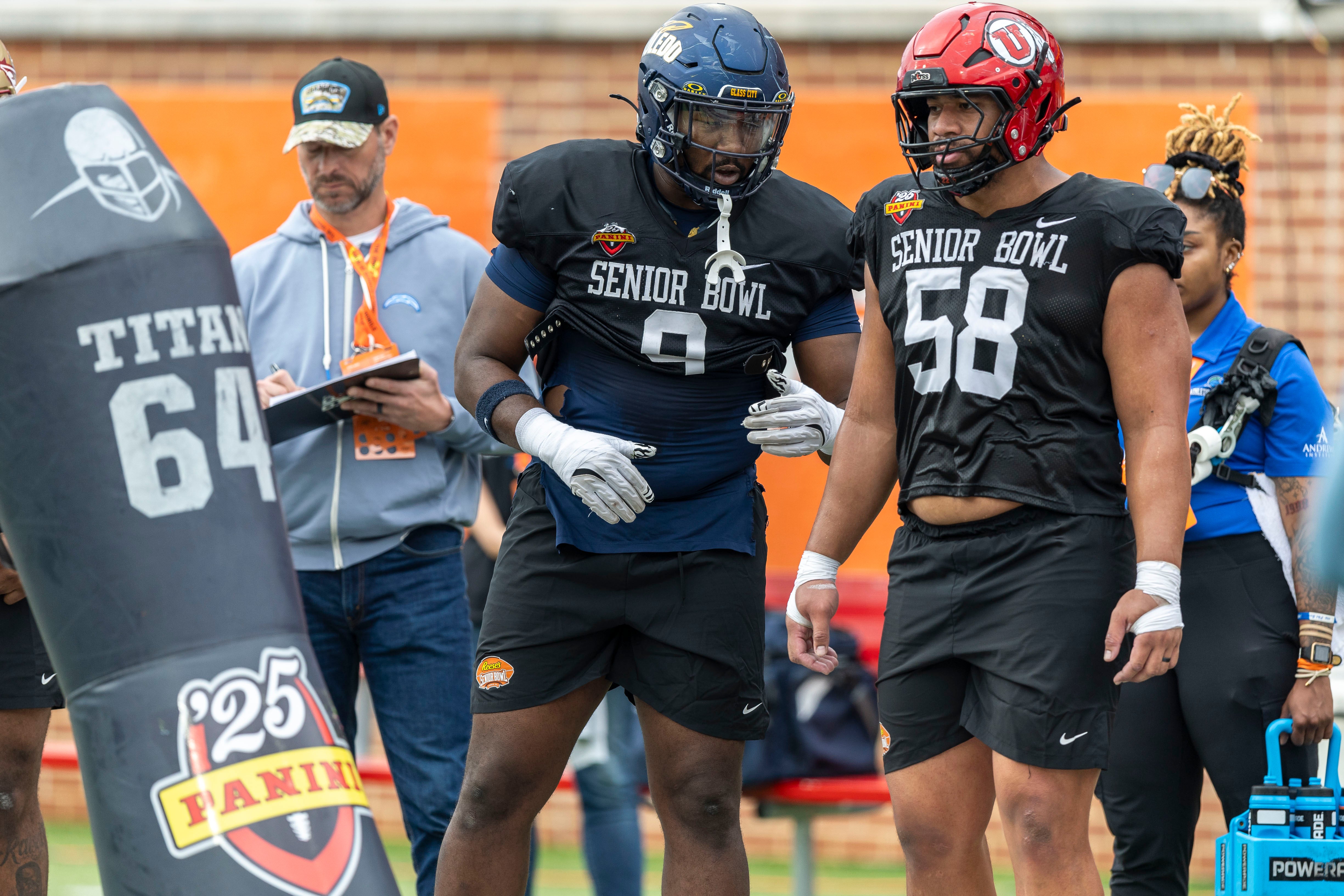 Jan 30, 2025; Mobile, AL, USA; National team defensive lineman Darius Alexander of Toledo (9) and National team defensive lineman Junior Tafuna of Utah (58) talks as they go through drills during Senior Bowl practice for the National team at Hancock Whitney Stadium.