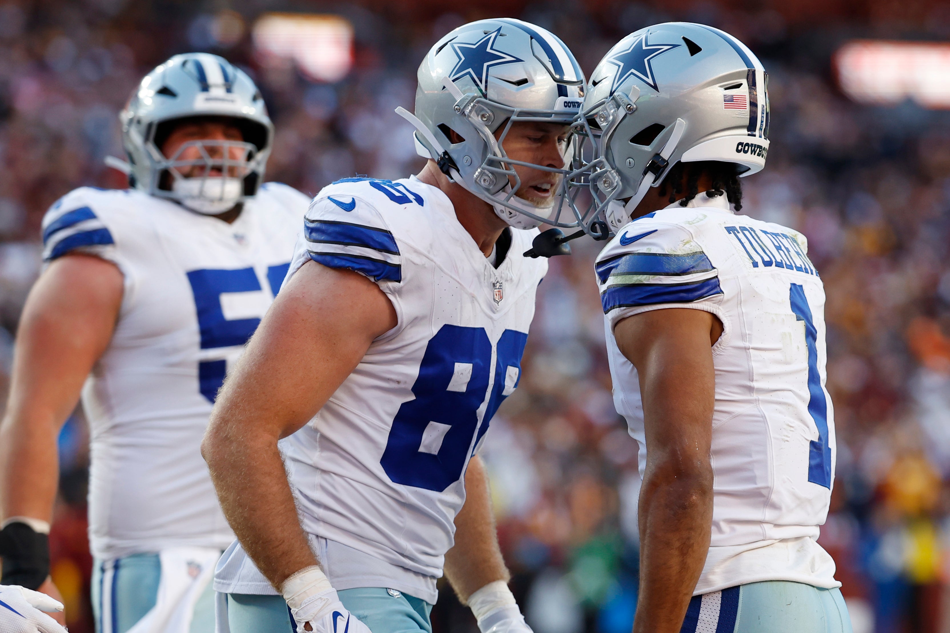 Dallas Cowboys wide receiver Jalen Tolbert (1) celebrates with Cowboys tight end Luke Schoonmaker (86) after catching a touchdown pass against the Washington Commanders during the third quarter at Northwest Stadium.