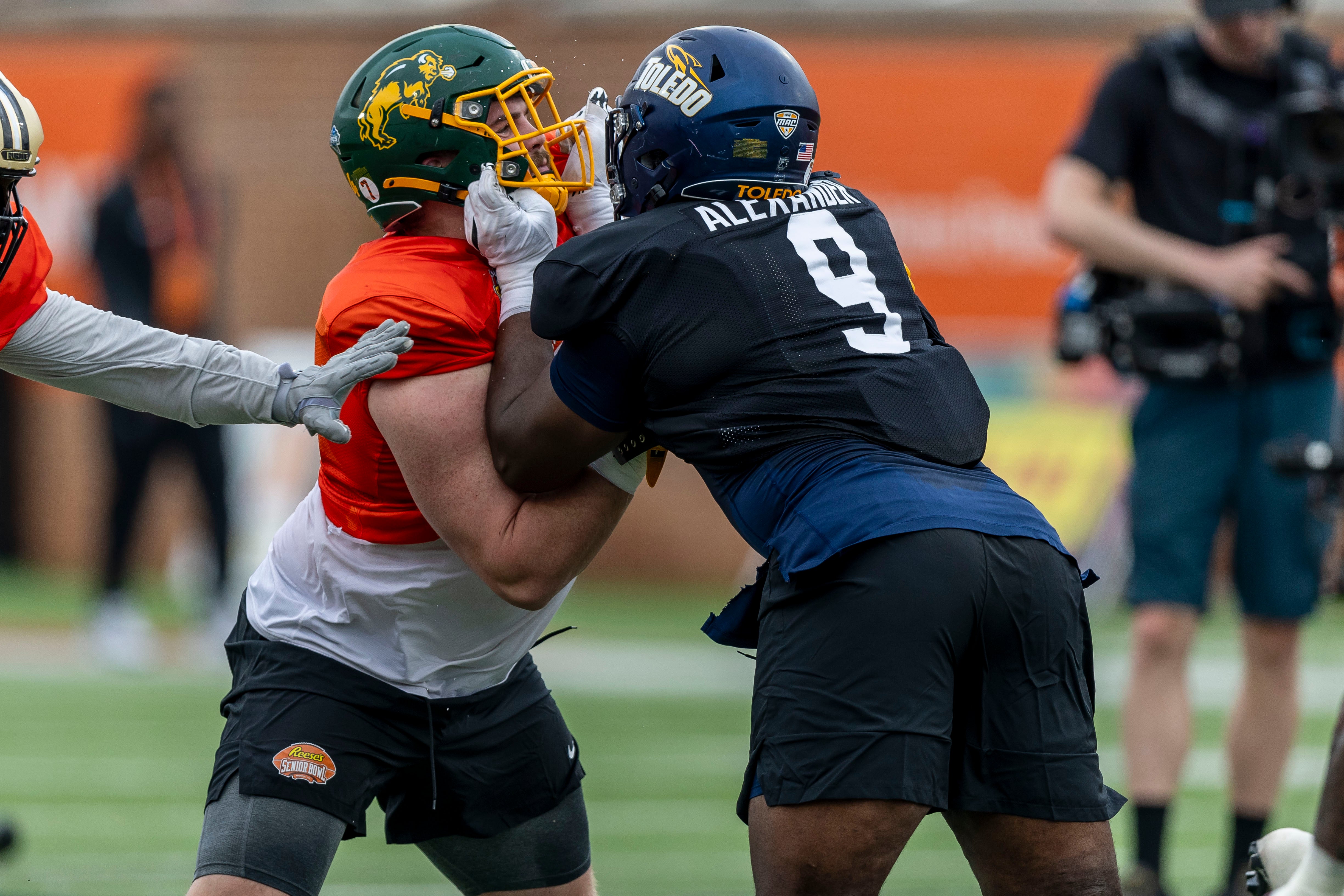 Jan 30, 2025; Mobile, AL, USA; National team offensive lineman Grey Zabel of North Dakota State (77) works against National team defensive lineman Darius Alexander of Toledo (9) during Senior Bowl practice for the National team at Hancock Whitney Stadium.