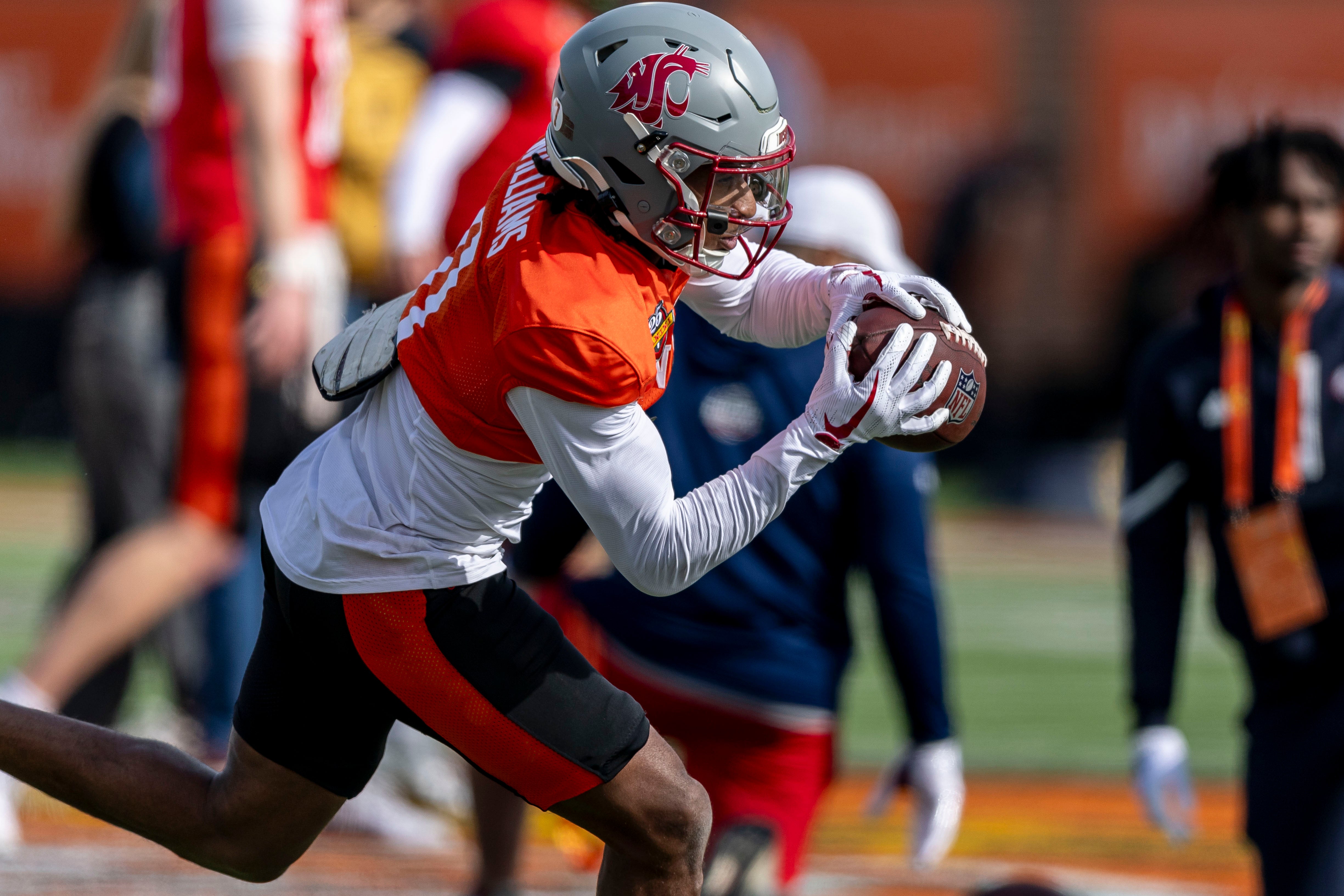 Jan 28, 2025; Mobile, AL, USA; National team wide receiver Kyle Williams of Washington State (11) grabs a pass during Senior Bowl practice for the National team at Hancock Whitney Stadium.