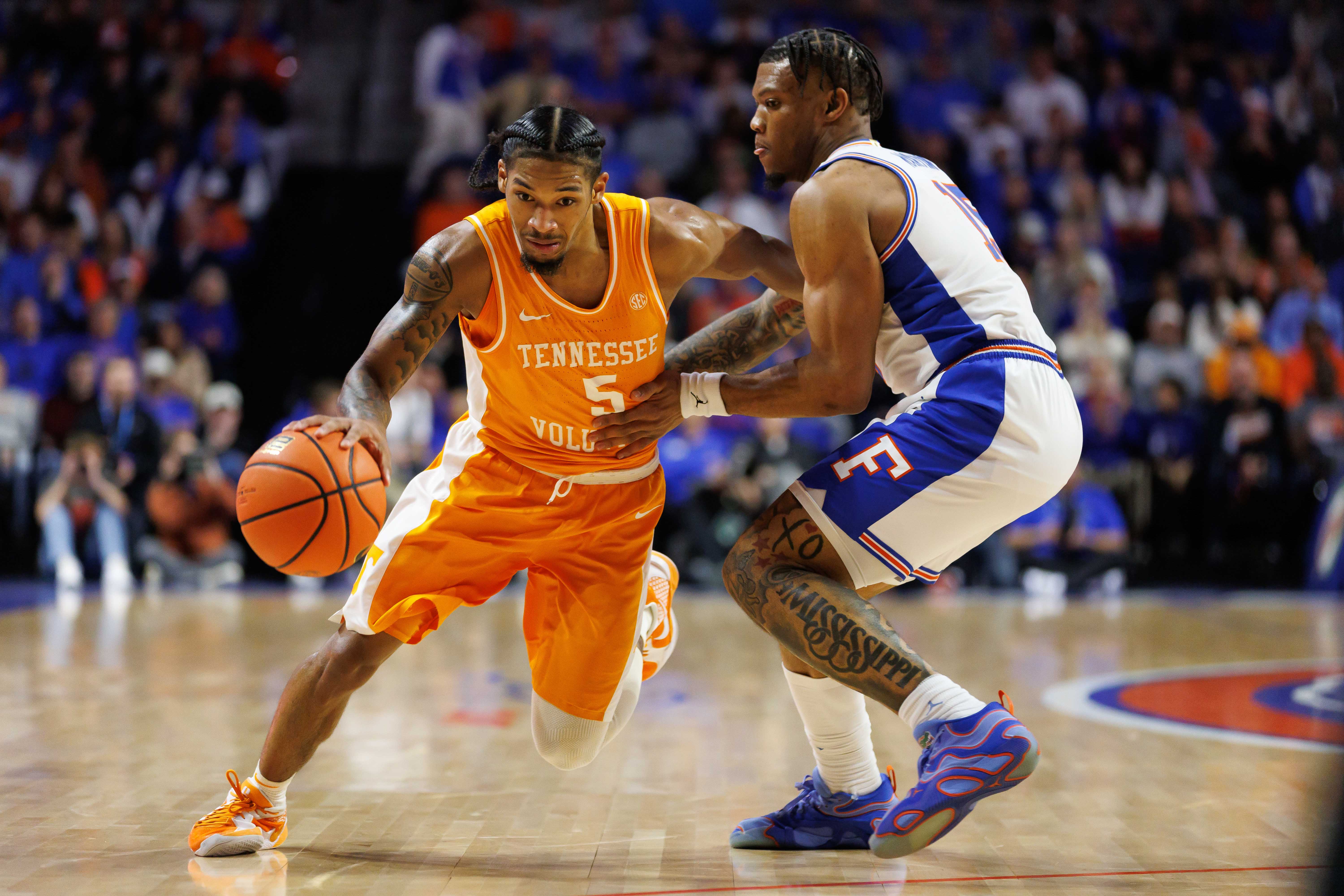 Jan 7, 2025; Gainesville, Florida, USA; Tennessee Volunteers guard Zakai Zeigler (5) drives to the basket past Florida Gators guard Alijah Martin (15) during the first half at Exactech Arena at the Stephen C. O'Connell Center.