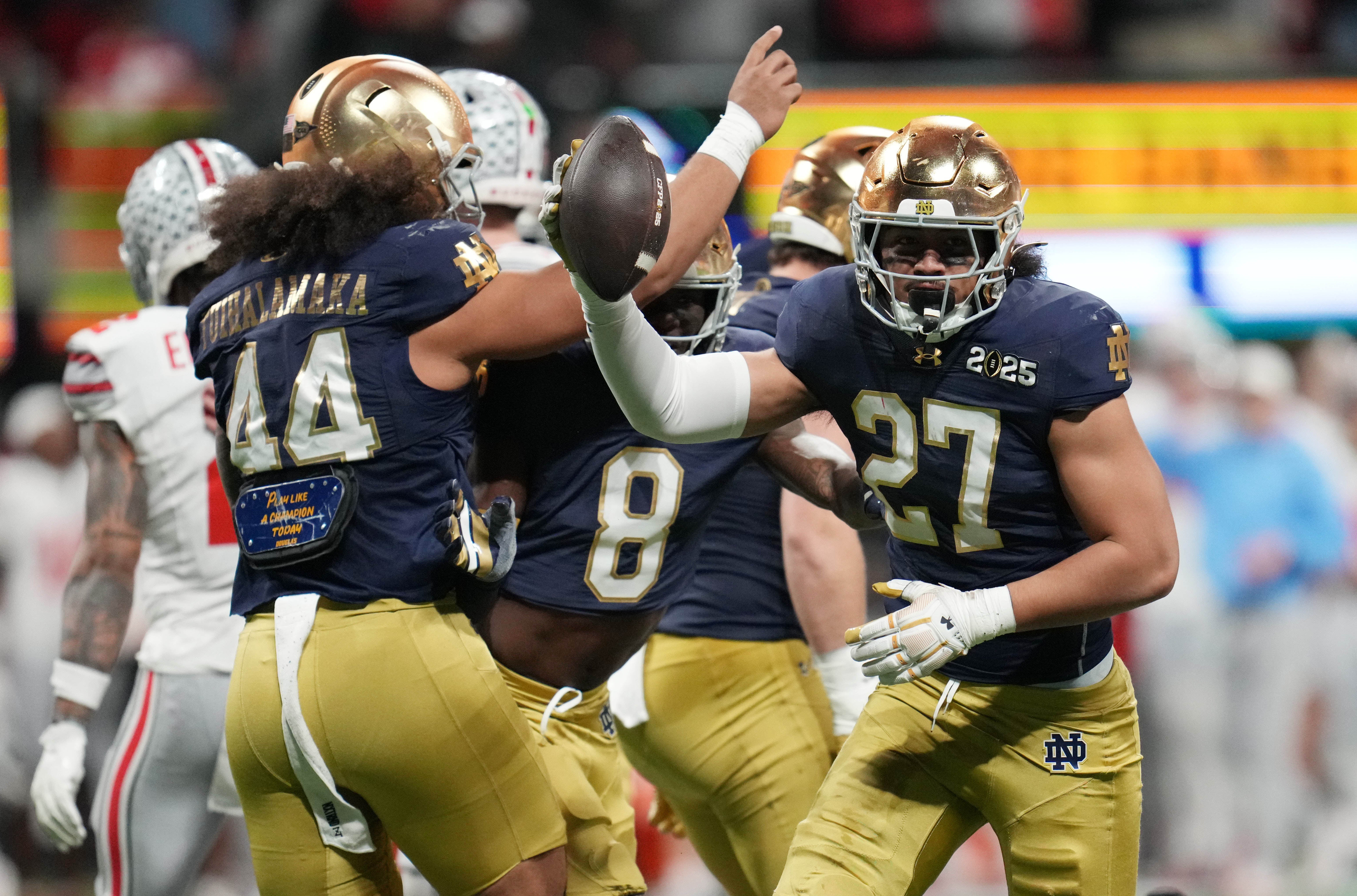 Notre Dame Fighting Irish linebacker Kyngstonn Viliamu-Asa (27) recovers a fumble against the Ohio State Buckeyes in the second half in the CFP National Championship college football game at Mercedes-Benz Stadium.
