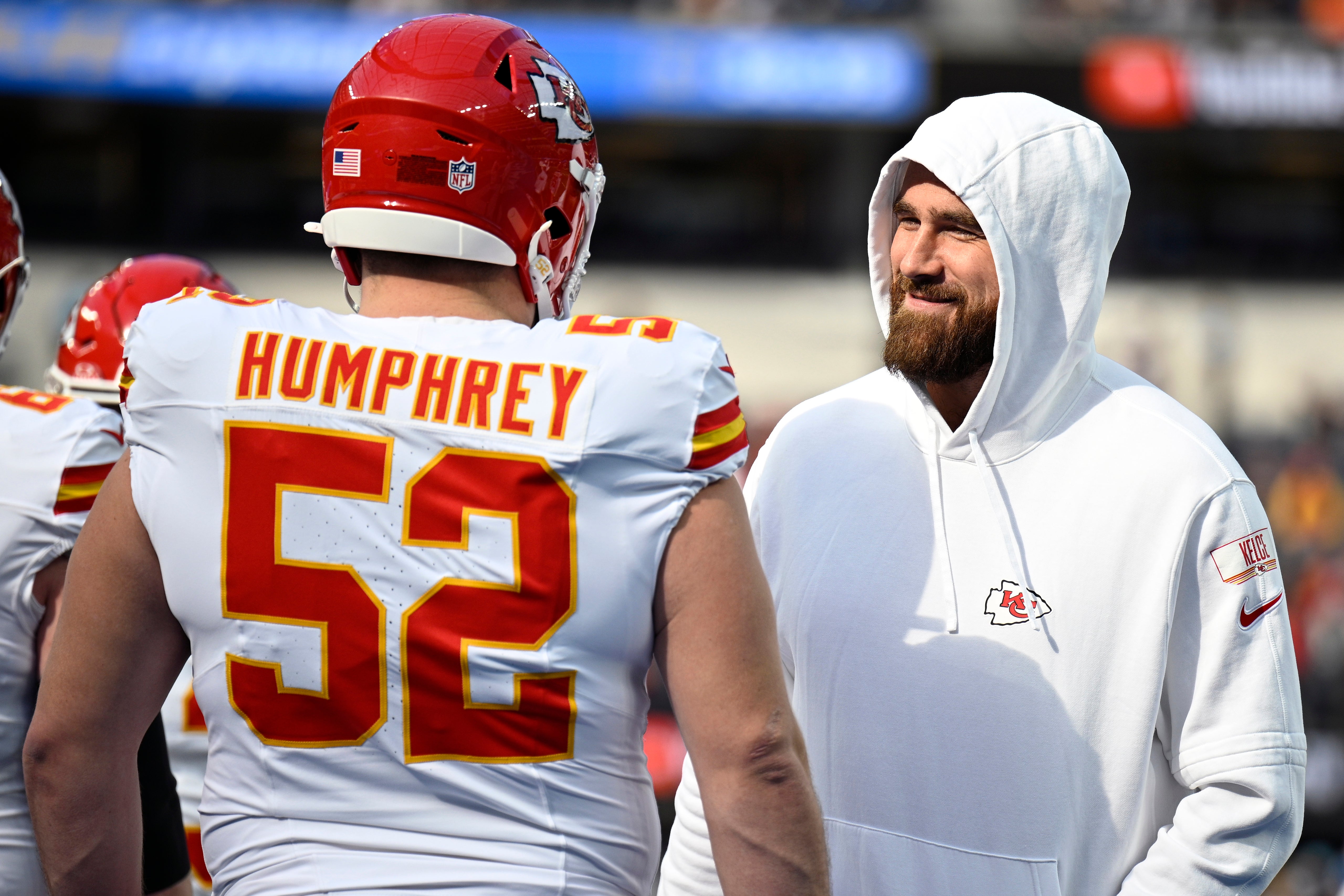 Jan 7, 2024; Inglewood, California, USA; Kansas City Chiefs tight end Travis Kelce (right) talks with center Creed Humphrey (52) before the game against the Los Angeles Chargers at SoFi Stadium.