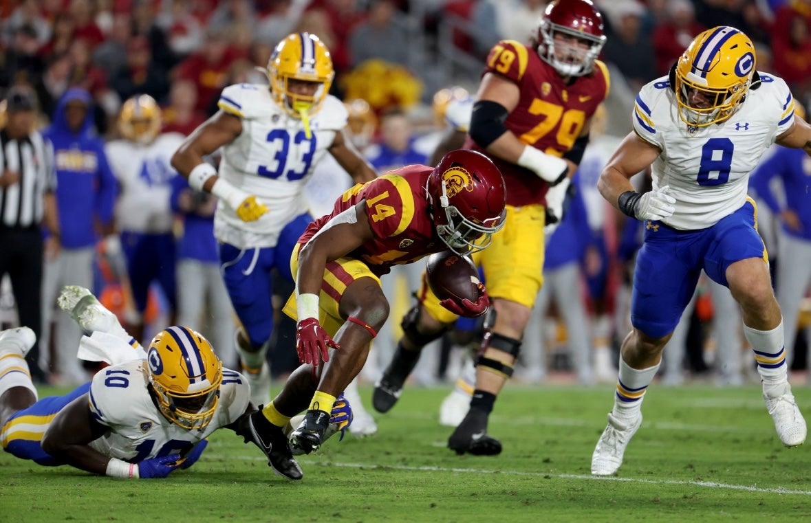 USC Trojans running back Raleek Brown (14) runs with a ball against California Golden Bears linebacker Femi Oladejo (10) during the second quarter at United Airlines Field at Los Angeles Memorial Coliseum.