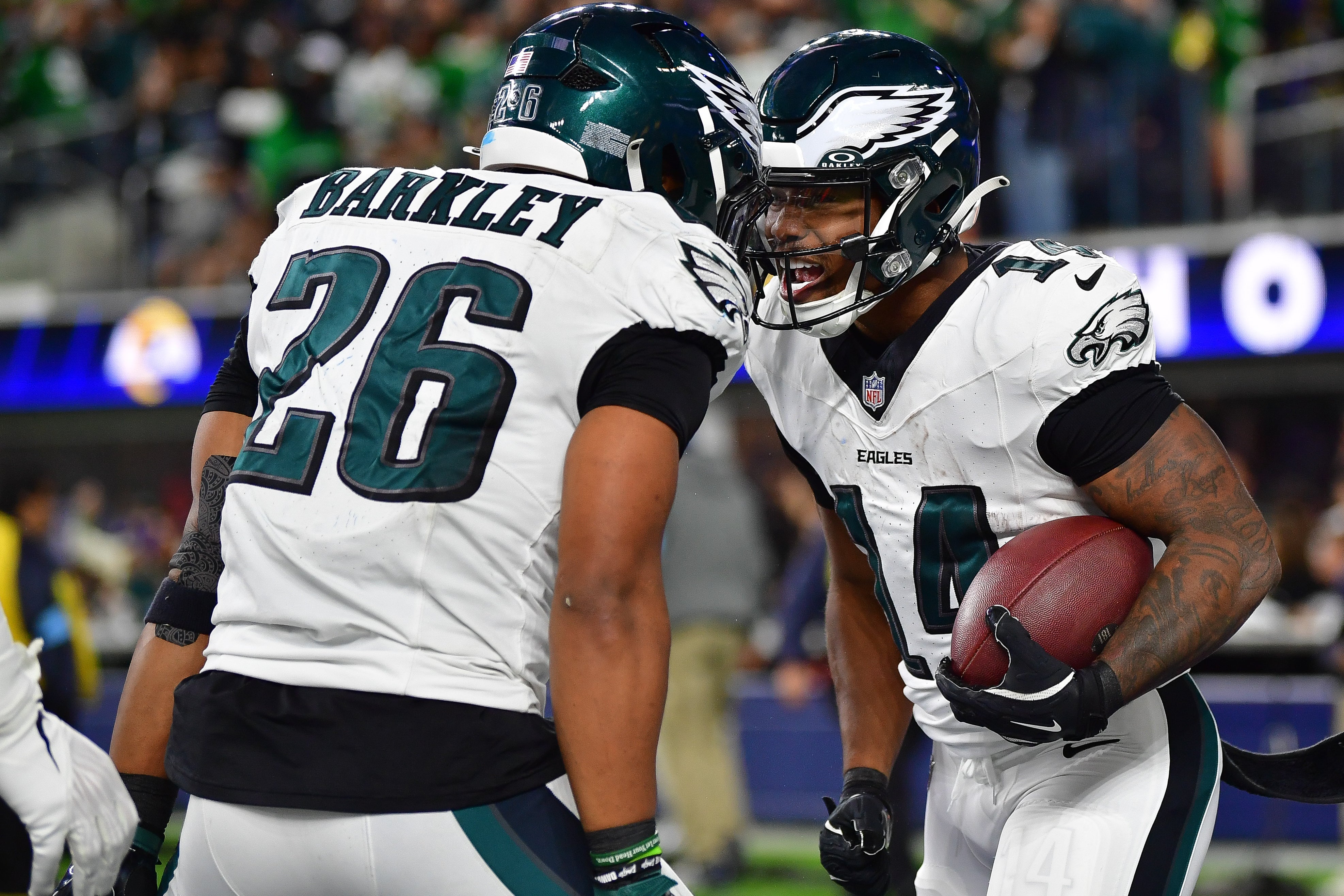 Philadelphia Eagles running back Kenneth Gainwell (14) celebrates his touchdown scored against the Los Angeles Rams with running back Saquon Barkley (26) during the second half at SoFi Stadium.