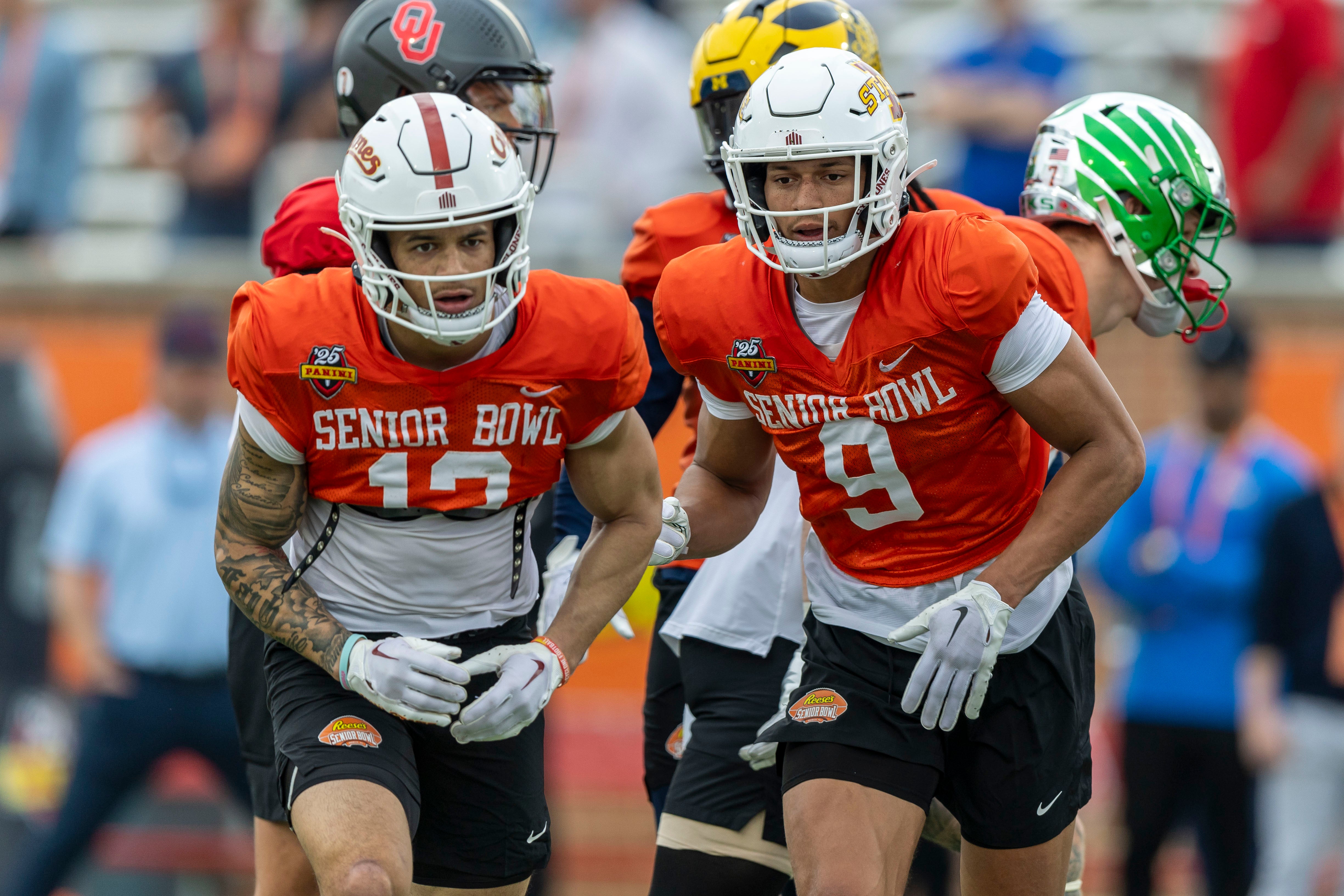 Jan 30, 2025; Mobile, AL, USA; National team wide receiver Jaylin Noel of Iowa State (12) and National team wide receiver Jayden Higgins of Iowa State (9) work through drills during Senior Bowl practice for the National team at Hancock Whitney Stadium. Mandatory Credit: Vasha Hunt-Imagn Images