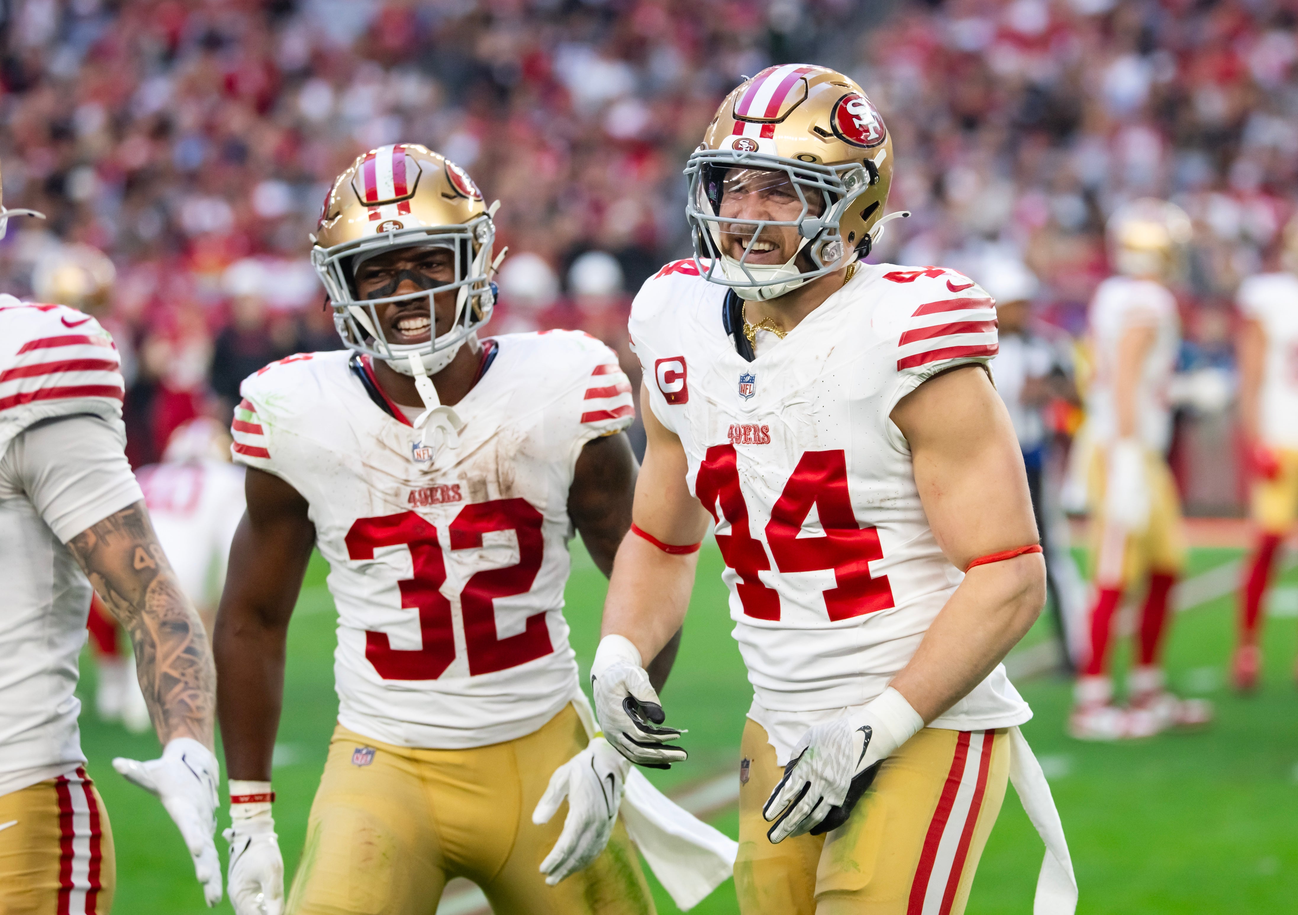 San Francisco 49ers running back Patrick Taylor Jr. (32) and fullback Kyle Juszczyk (44) celebrate a touchdown against the Arizona Cardinals at State Farm Stadium.
