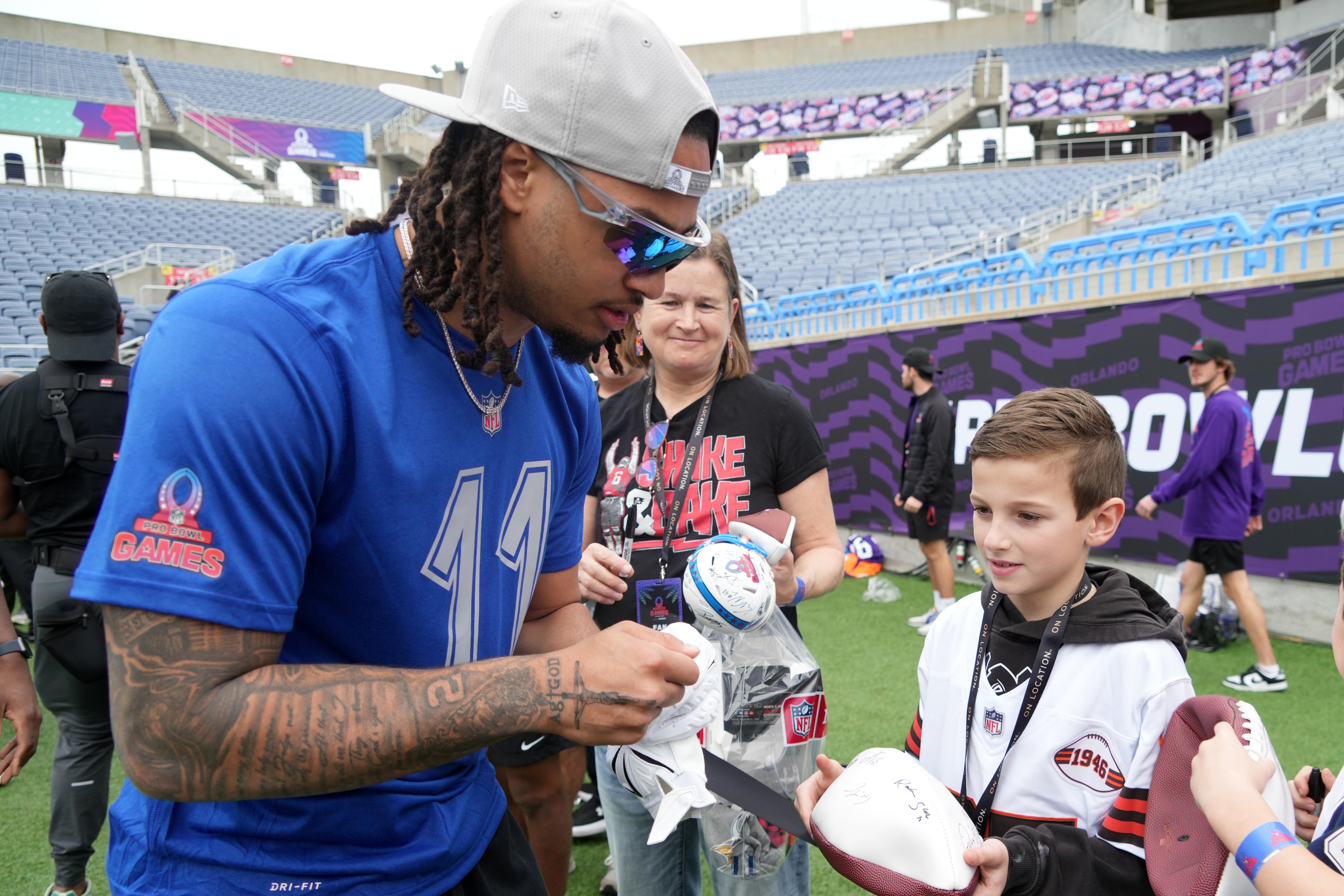 Seattle Seahawks receiver Jason Smith-Njigba (11) signs autographs during NFC Practice for the Pro Bowl Games at Camping World Stadium.