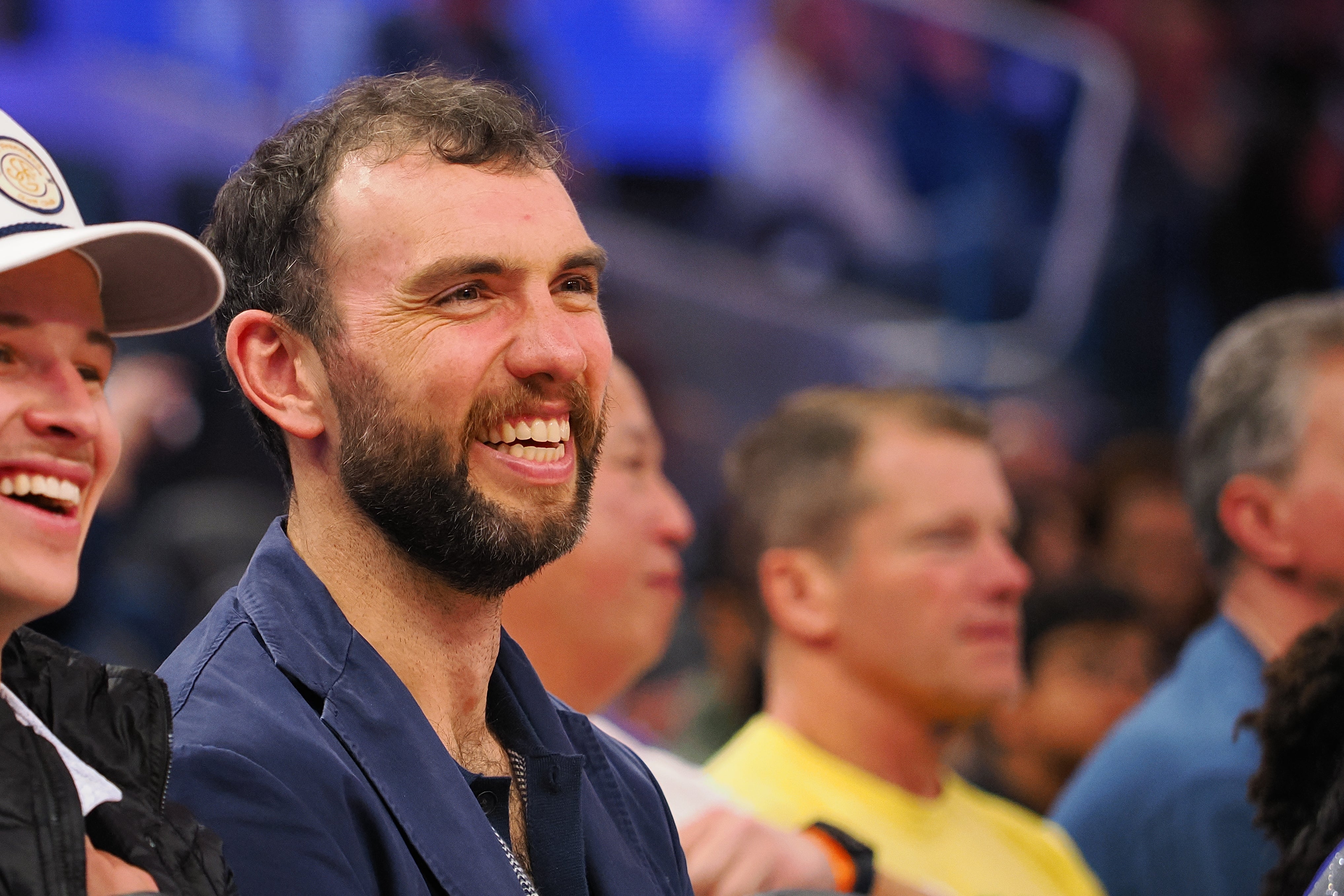Jan 5, 2025; San Francisco, California, USA; Retired NFL quarter Andrew Luck smiles court side during the fourth quarter of the game between the Golden State Warriors and Sacramento Kings at Chase Center.