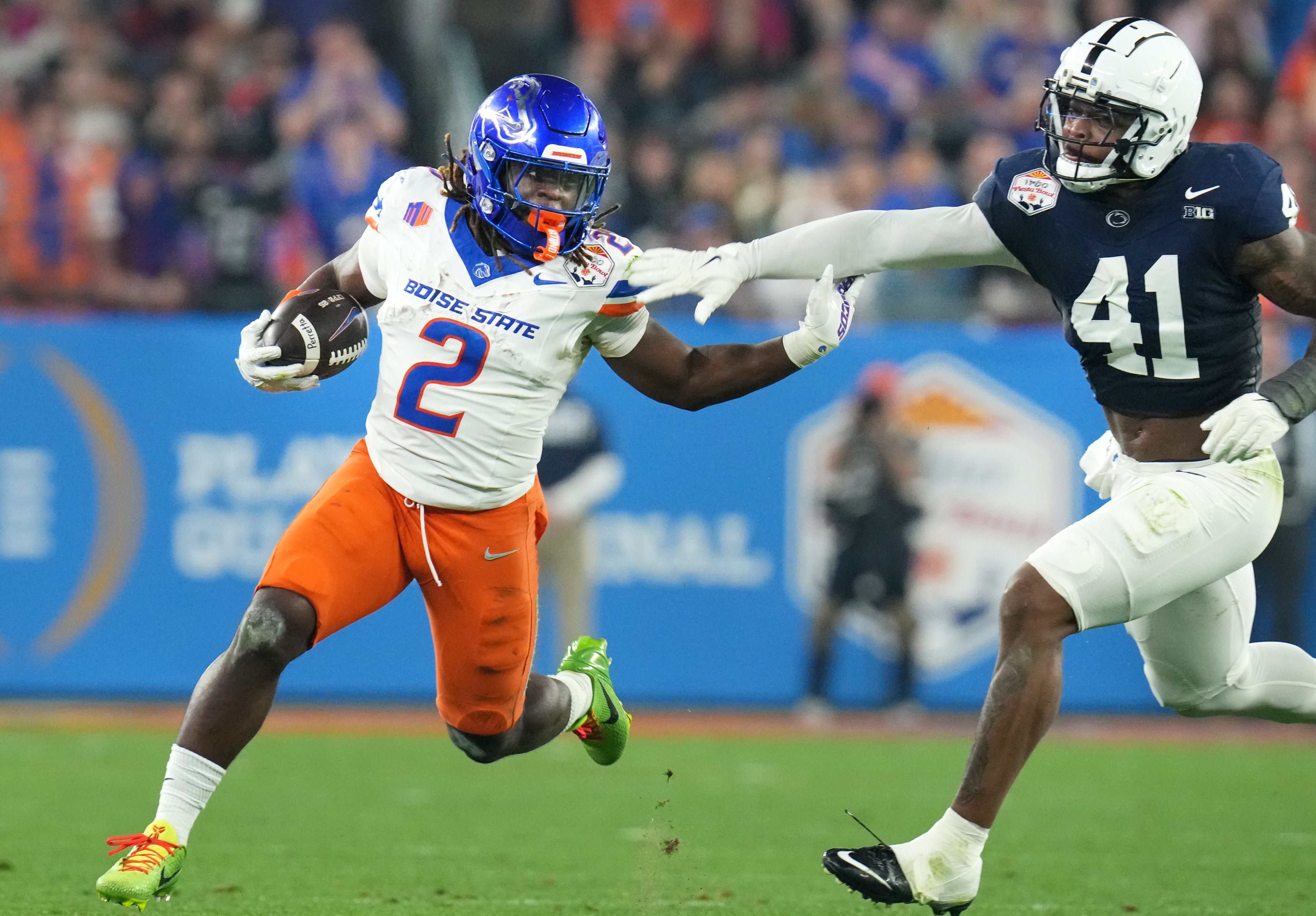 Boise State Broncos running back Ashton Jeanty (2) runs past Penn State Nittany Lions linebacker Kobe King (41) during their Vrbo Fiesta Bowl matchup at State Farm Stadium on Dec. 31, 2024.  