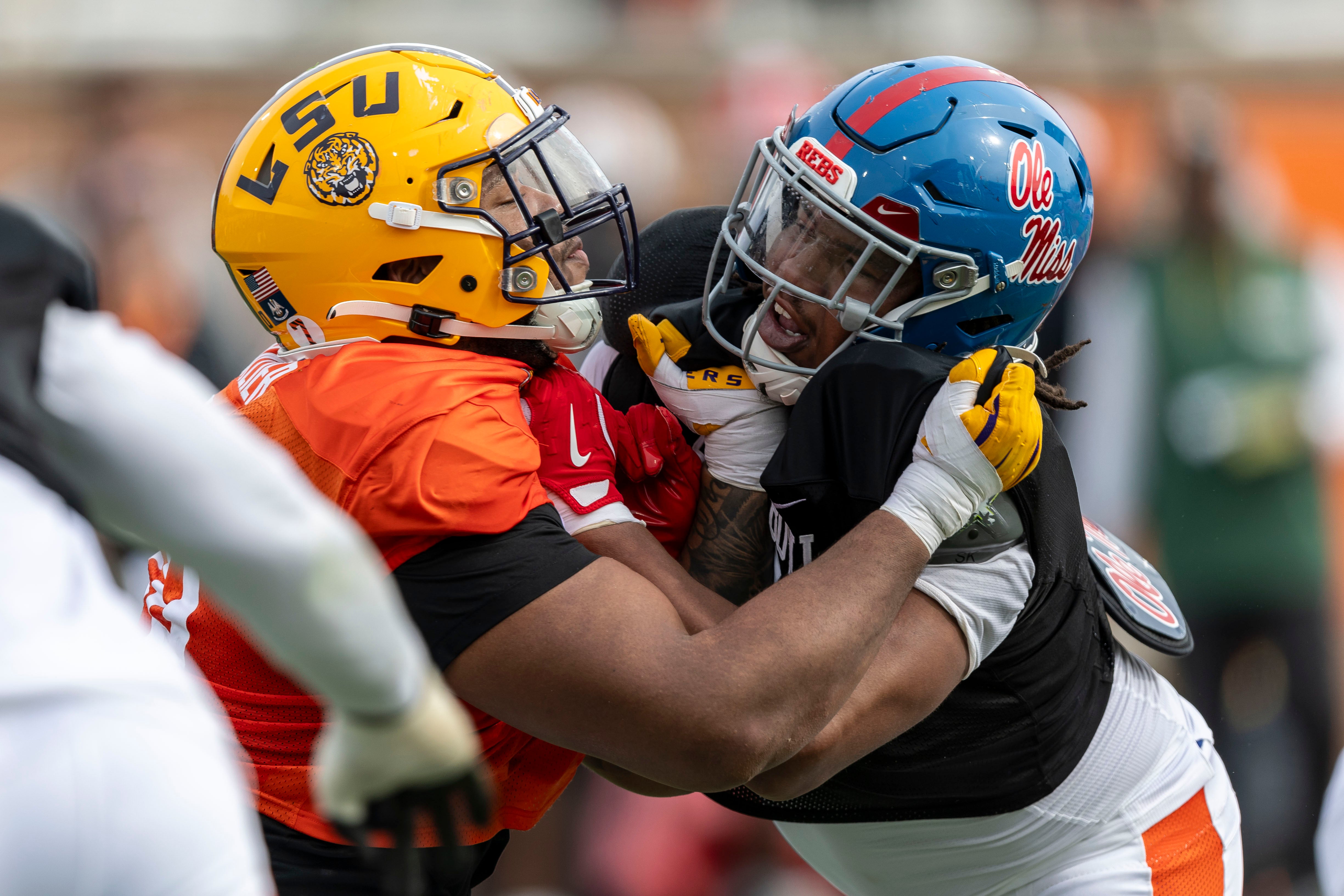 American team offensive lineman Miles Frazier of LSU (70) spars with American team defensive lineman Walter Nolen of Ole Miss (2) during Senior Bowl practice for the American team at Hancock Whitney Stadium.