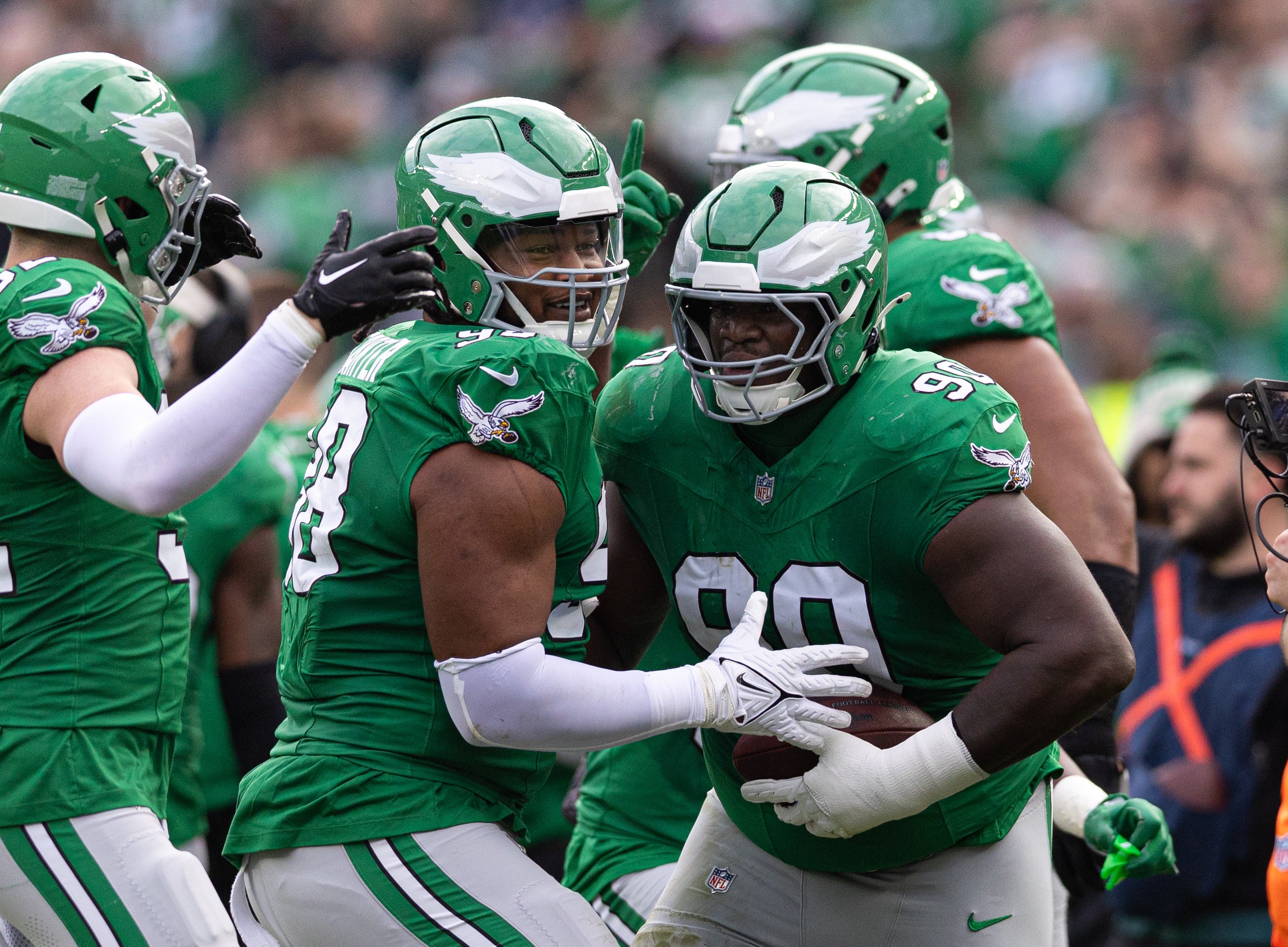 Philadelphia Eagles defensive tackle Jordan Davis (90) and defensive tackle Jalen Carter (98) celebrate a fumble recover against the Dallas Cowboys during the second quarter at Lincoln Financial Field.