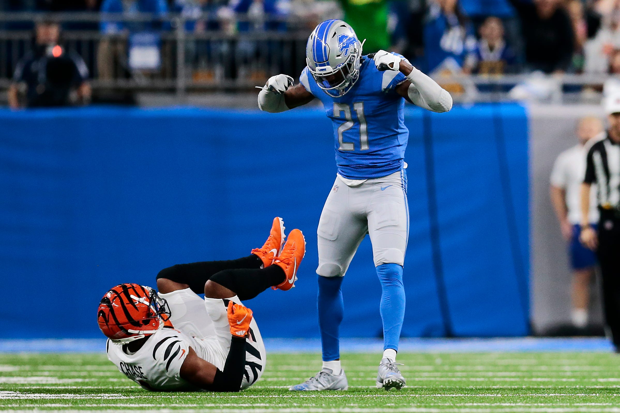 Detroit Lions free safety Tracy Walker III (21) stands and flexes over Cincinnati Bengals wide receiver Ja'Marr Chase (1) as he s called for a taunting penalty in the first quarter of the NFL Week 6 game between the Detroit Lions and the Cincinnati Bengals at Ford Field in Detroit on Sunday, Oct. 17, 2021. The Bengals led 10-0 at halftime. Cincinnati Bengals At Detroit Lions Week 6