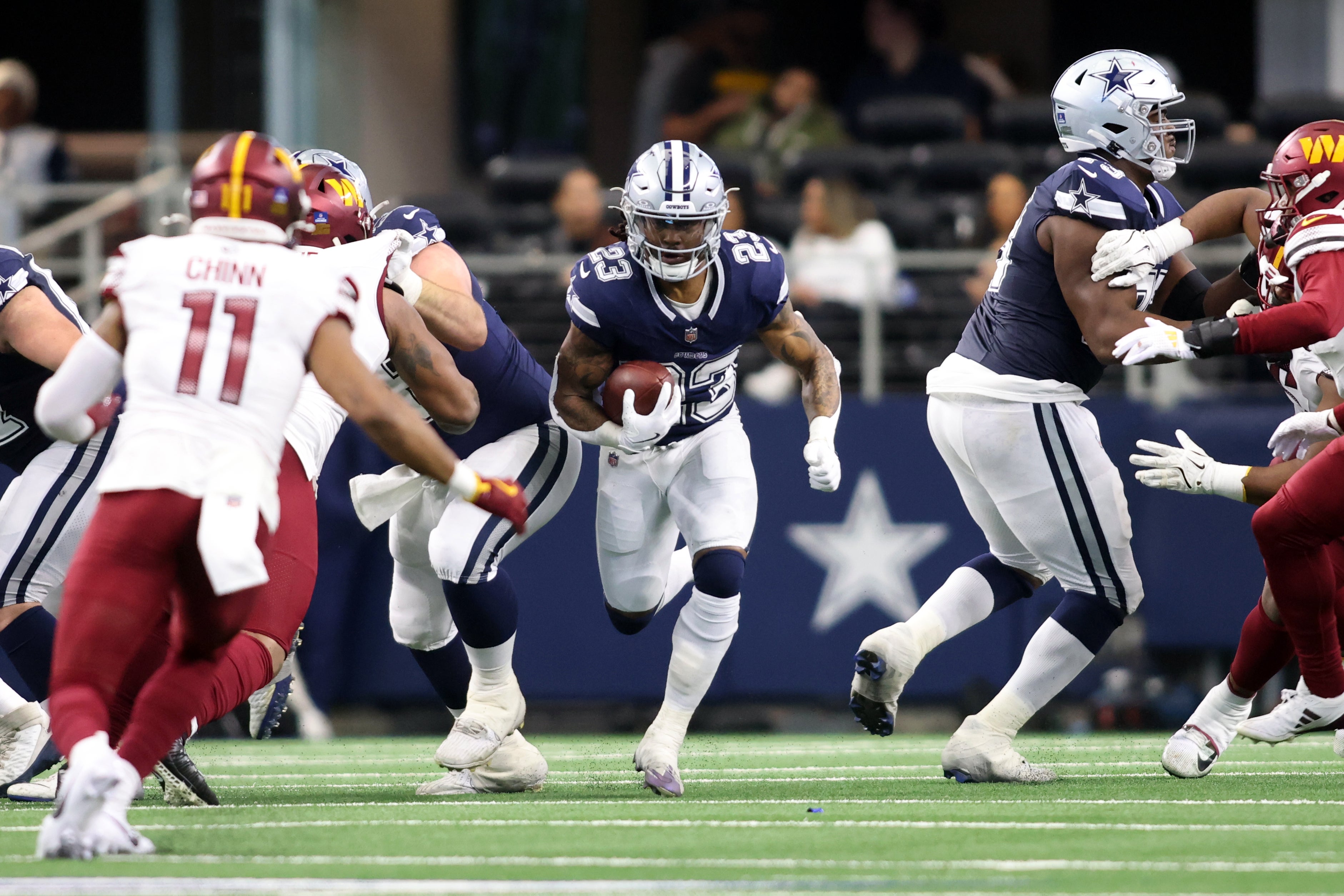 Dallas Cowboys running back Rico Dowdle (23) runs the ball against the Washington Commanders during the second quarter at AT&T Stadium.