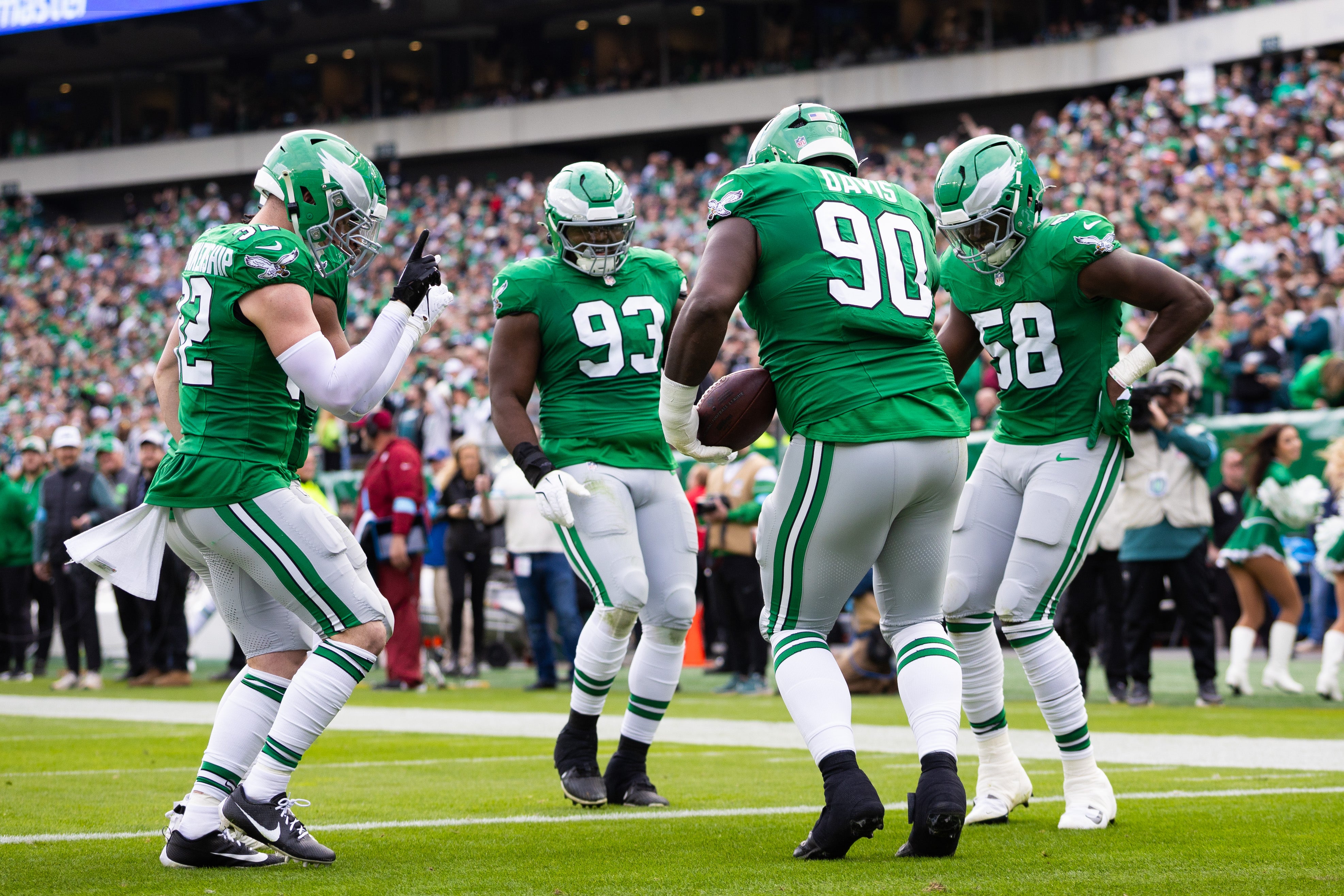Philadelphia Eagles Jordan Davis (90) and Milton Williams (93) and Jalyx Hunt (58) and Reed Blankenship (32) celebrate during the second quarter against the Dallas Cowboys at Lincoln Financial Field.