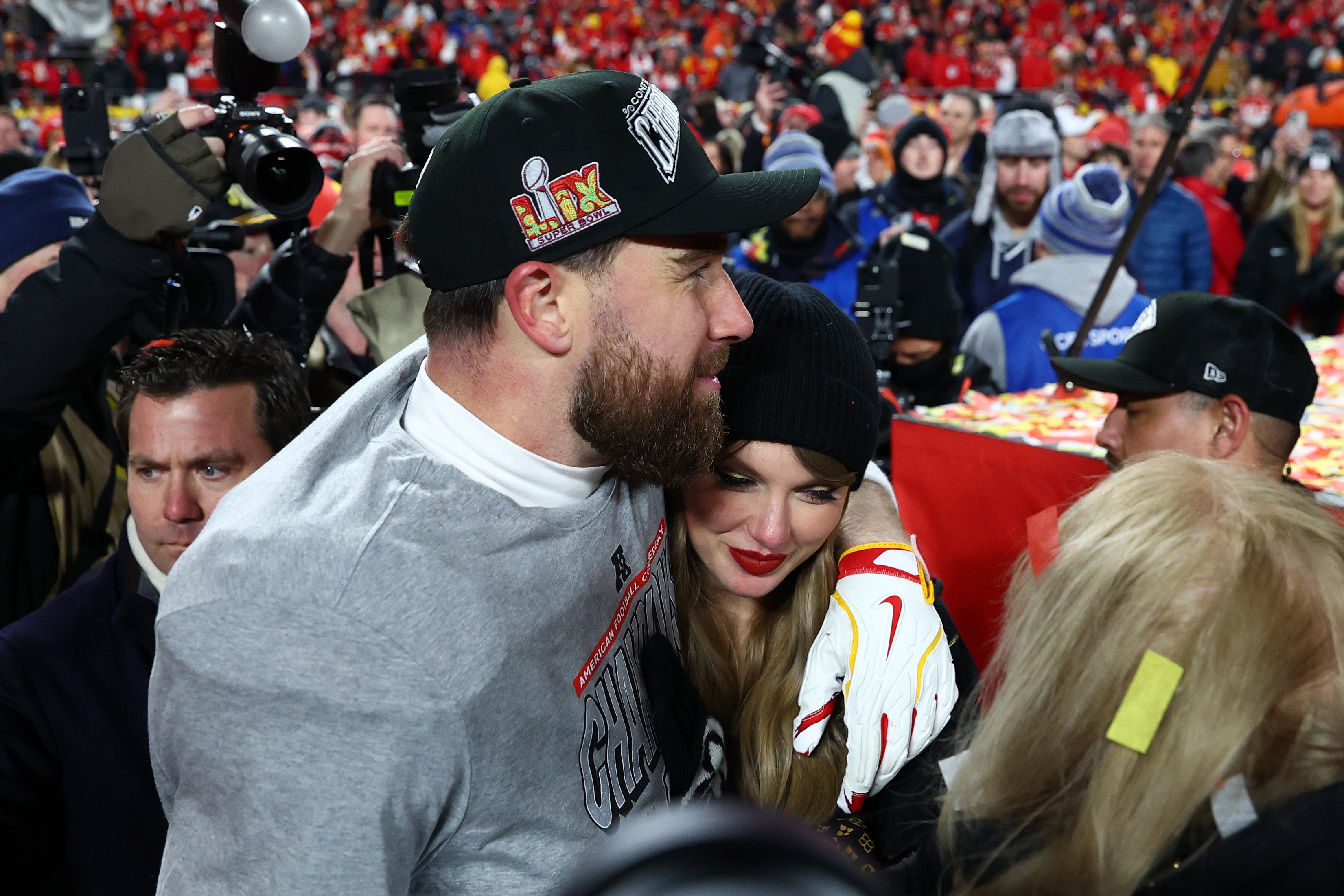 Jan 26, 2025; Kansas City, MO, USA; Recording artist Taylor Swift and Kansas City Chiefs tight end Travis Kelce (87) react after the AFC Championship game against the Buffalo Bills at GEHA Field at Arrowhead Stadium.