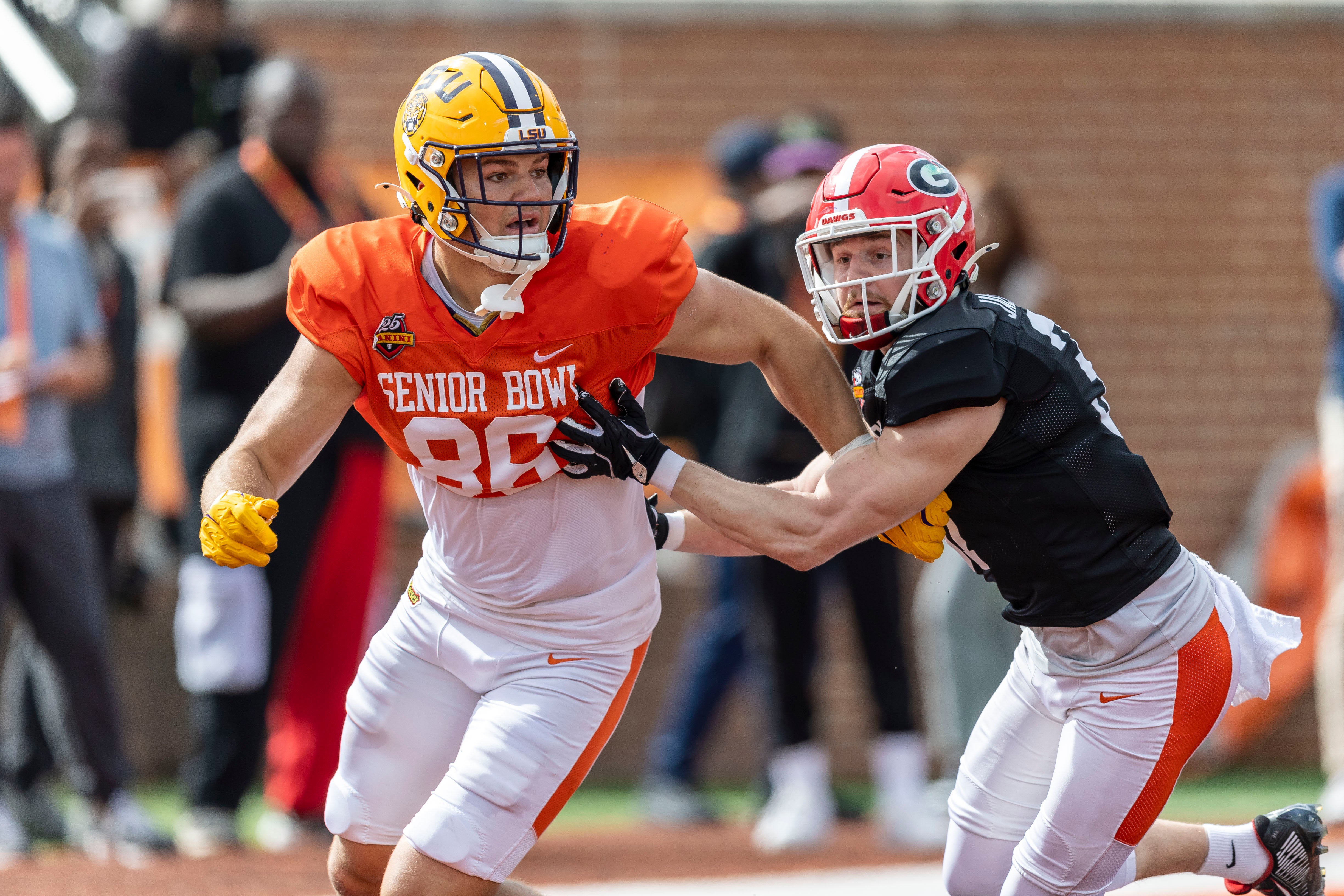 American team tight end Mason Taylor of LSU (86) and American team defensive back Dan Jackson of Georgia (37) spar during Senior Bowl practice for the American team at Hancock Whitney Stadium.
