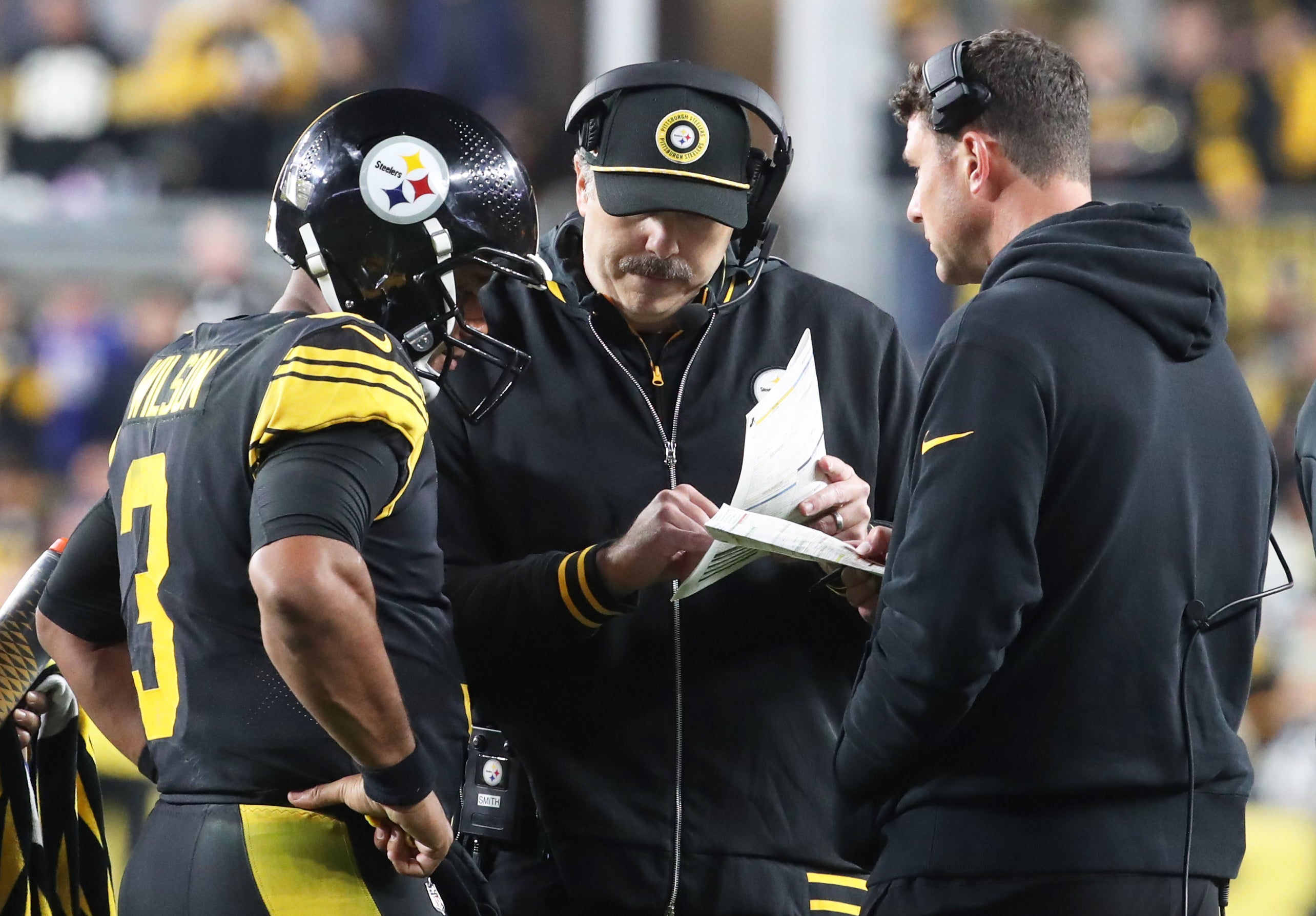 Oct 28, 2024; Pittsburgh, Pennsylvania, USA; Pittsburgh Steelers quarterback Russell Wilson (3) talks with offensive coordinator Arthur Smith (middle) and quarterbacks coach Tom Arth (right) against the New York Giants during the fourth quarter at Acrisure Stadium.