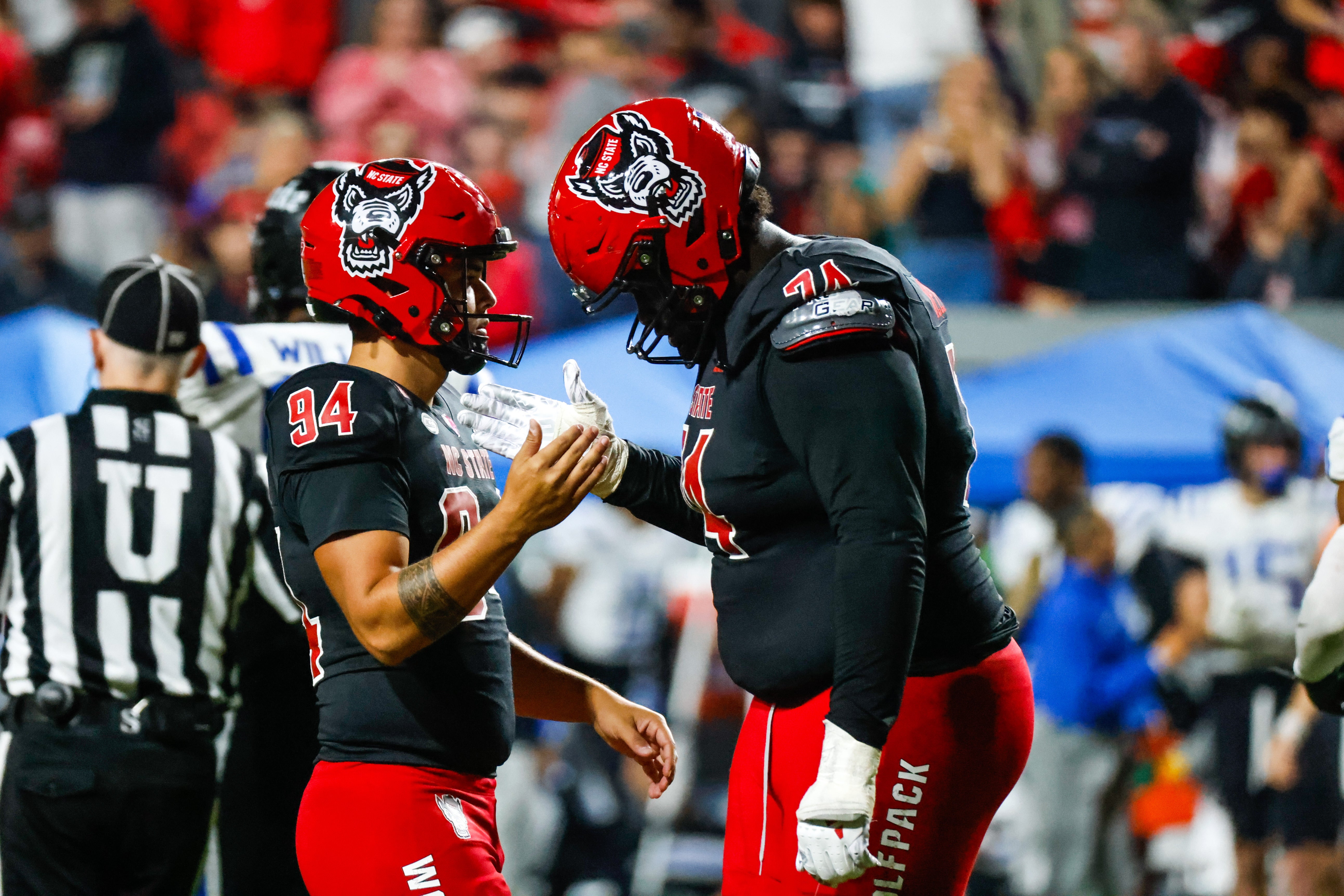 North Carolina State Wolfpack place kicker Kanoah Vinesett (94) and offensive tackle Anthony Belton (74) celebrate during the second half of the game against Duke Blue Devils at Carter-Finley Stadium.