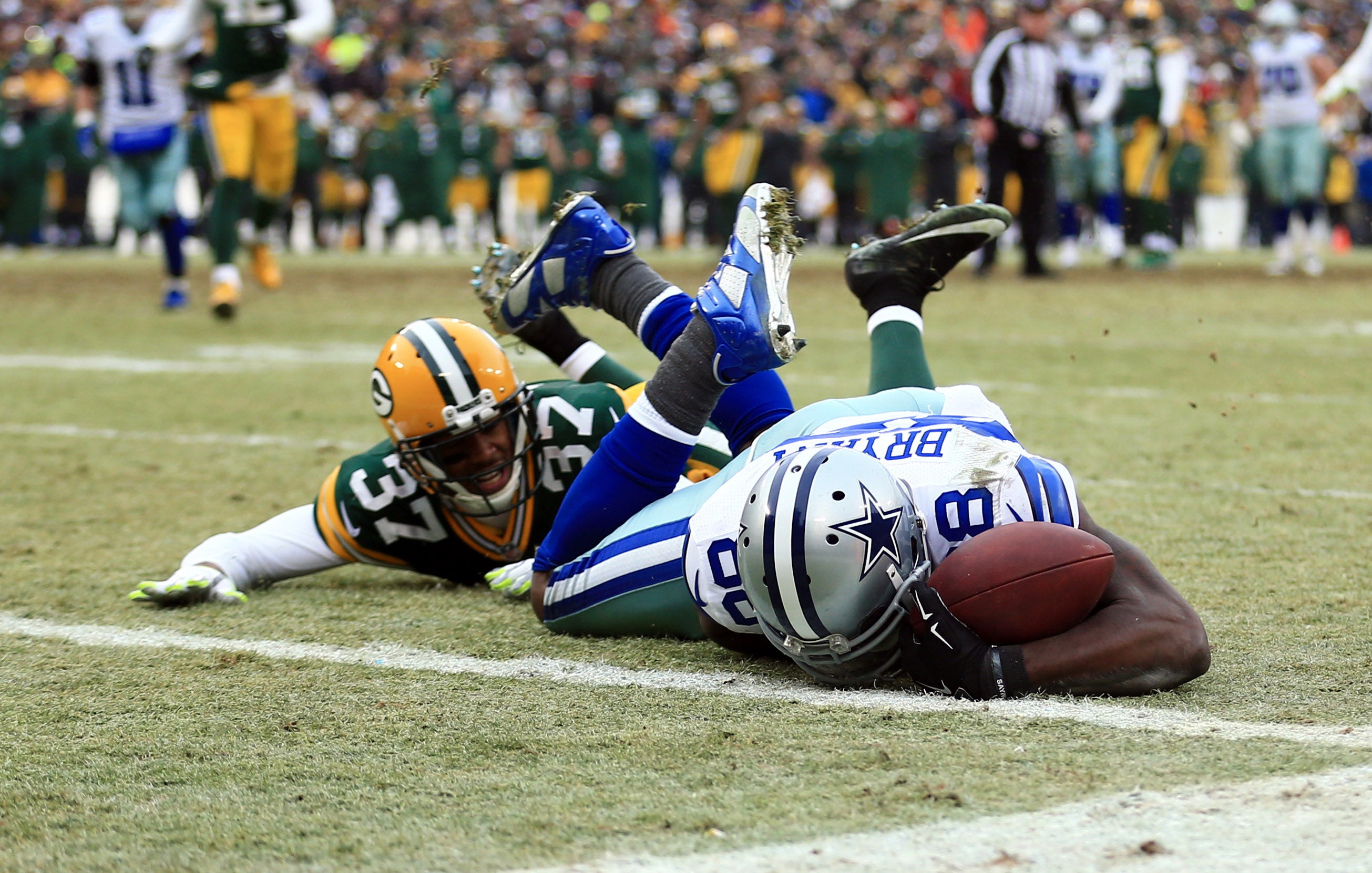 Jan 11, 2015; Green Bay, WI, USA; Dallas Cowboys wide receiver Dez Bryant (88) is unable to catch a pass against Green Bay Packers cornerback Sam Shields (37) in the fourth quarter in the 2014 NFC Divisional playoff football game at Lambeau Field.
