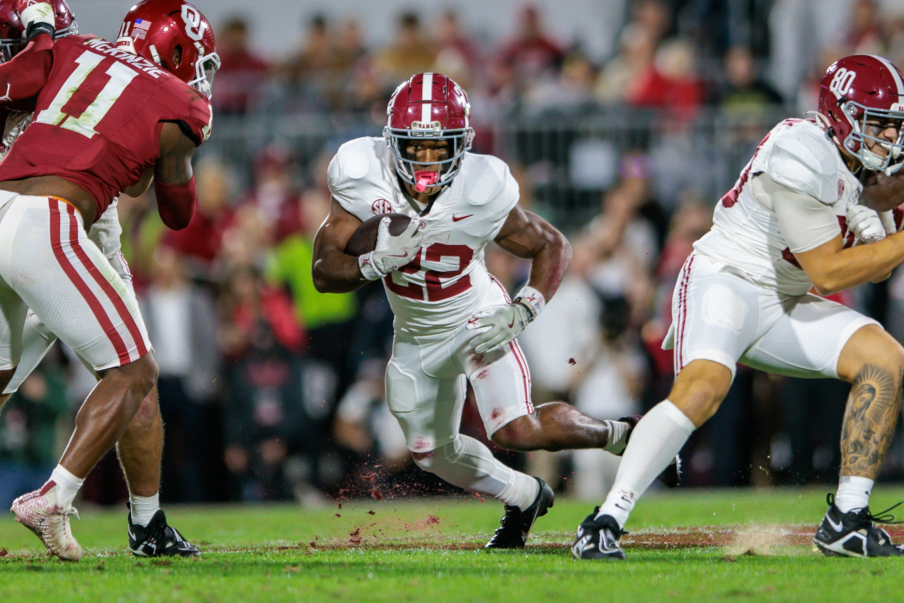 Nov 23, 2024; Norman, Oklahoma, USA; Alabama Crimson Tide running back Justice Haynes (22) runs the ball during the first quarter against the Oklahoma Sooners at Gaylord Family-Oklahoma Memorial Stadium.