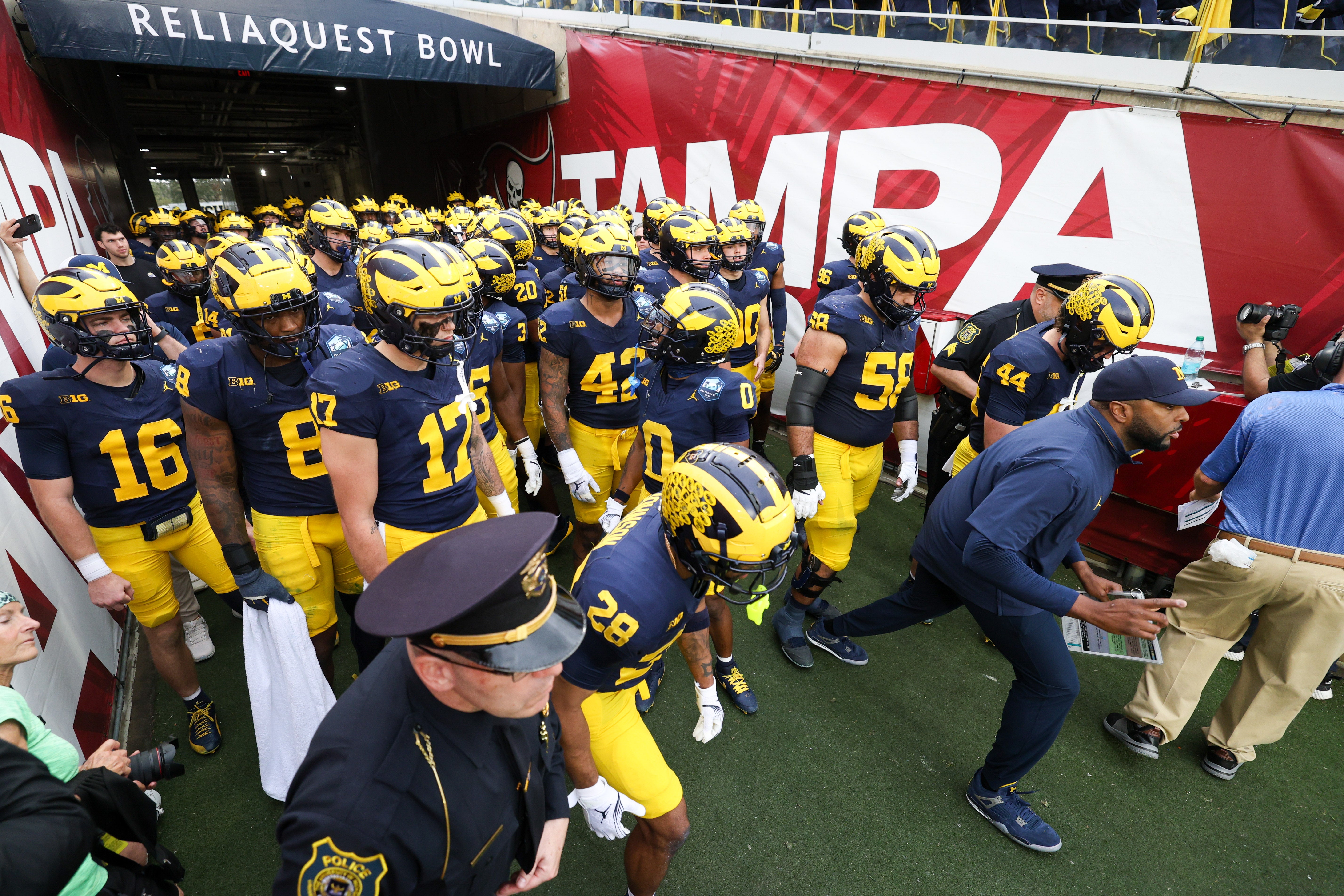 Dec 31, 2024; Tampa, FL, USA; Michigan Wolverines take the field for the ReliaQuest Bowl against the Alabama Crimson Tide at Raymond James Stadium.