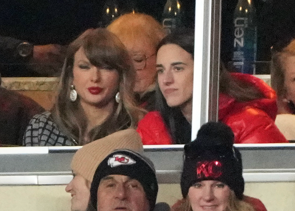 Jan 18, 2025; Kansas City, Missouri, USA; Recording artist Taylor Swift (upper middle) sits with Indiana Fever guard Caitlin Clark (upper right) during the fourth quarter of a 2025 AFC divisional round game between the Kansas City Chiefs and the Houston Texans at GEHA Field at Arrowhead Stadium.