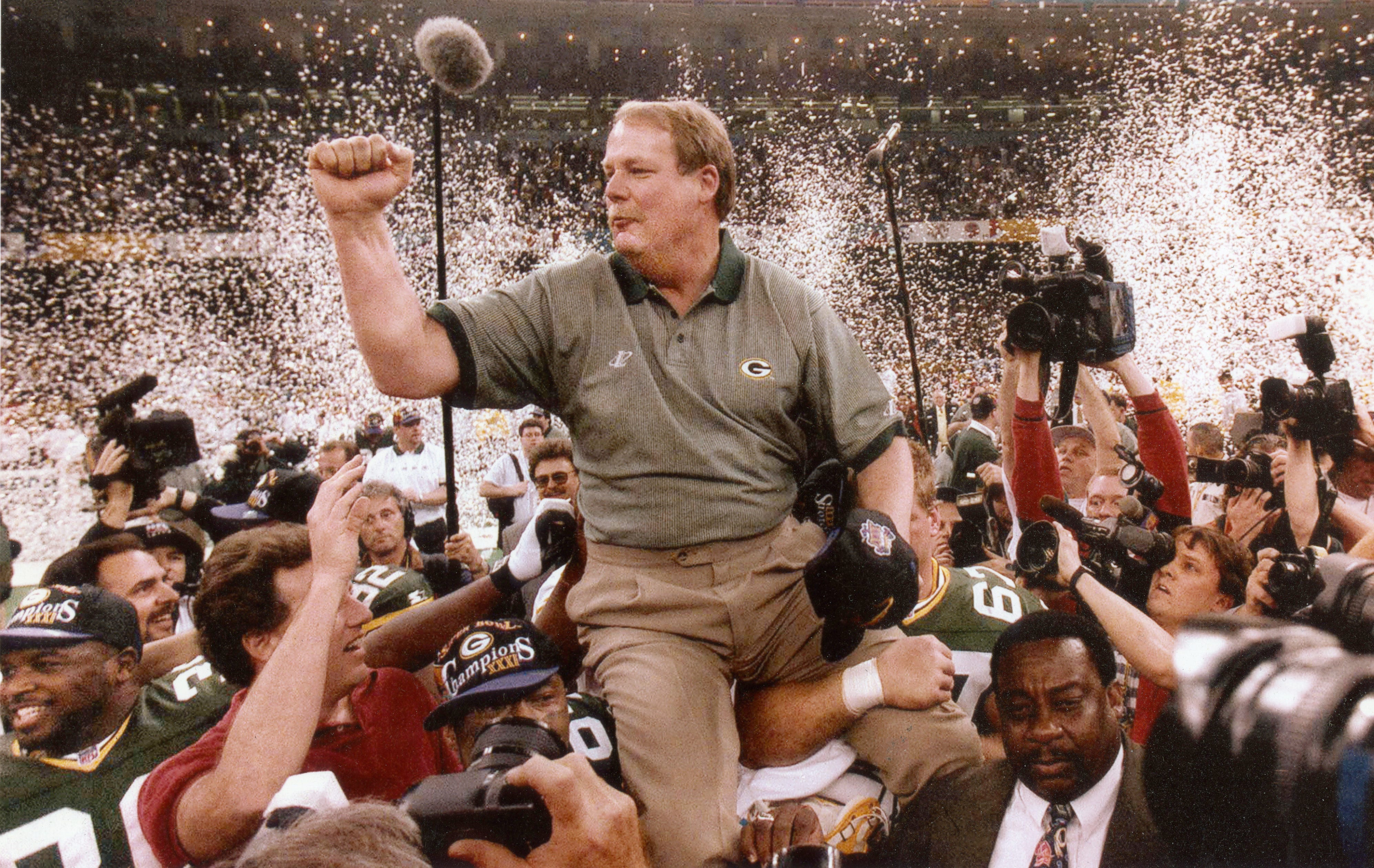 Green Bay Packers coach Mike Holmgren being carried by his players after the Packers won Super Bowl XXXI over the New England Patriots, 35-21.
