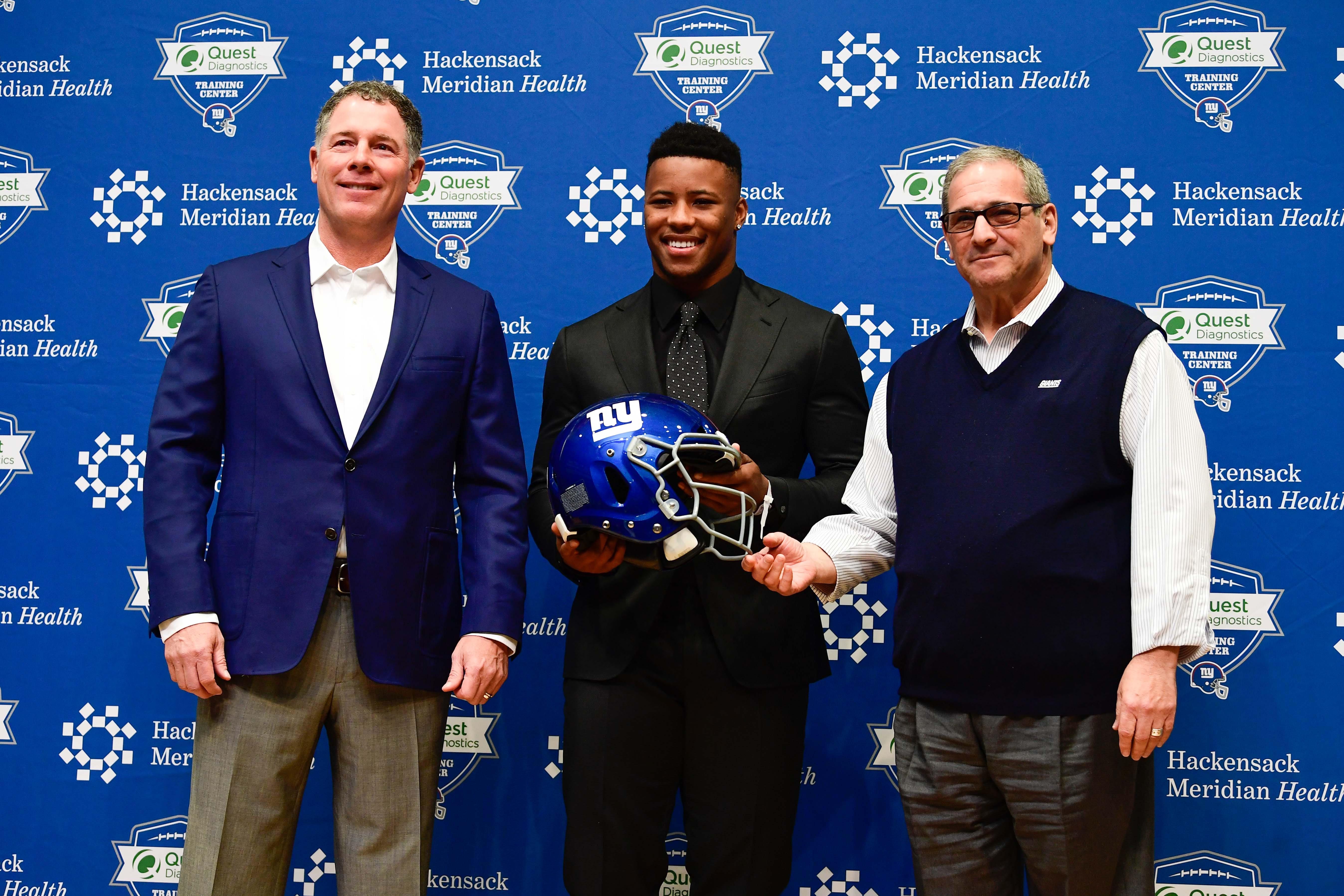 New York Giants head coach Pat Shurmur (left), first round draft pick Saquon Barkley (center), and general manager Dave Gettleman (right) pose for a photo during a press conference at Quest Diagnostics Training Center.