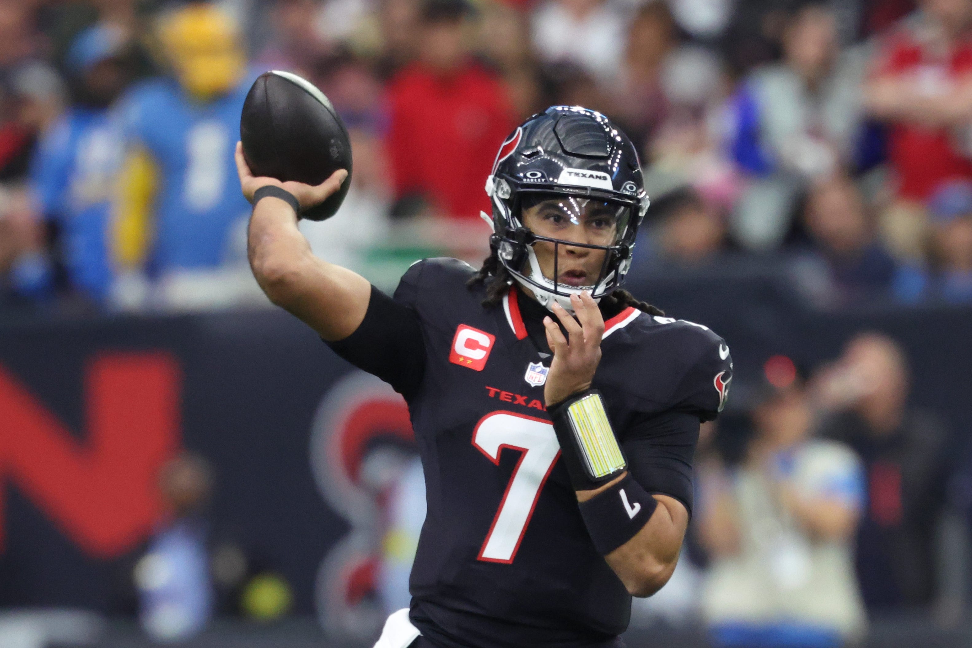 Jan 11, 2025; Houston, Texas, USA; Houston Texans quarterback C.J. Stroud (7) looks to pass during the first quarter against the Los Angeles Chargers in an AFC wild card game at NRG Stadium.