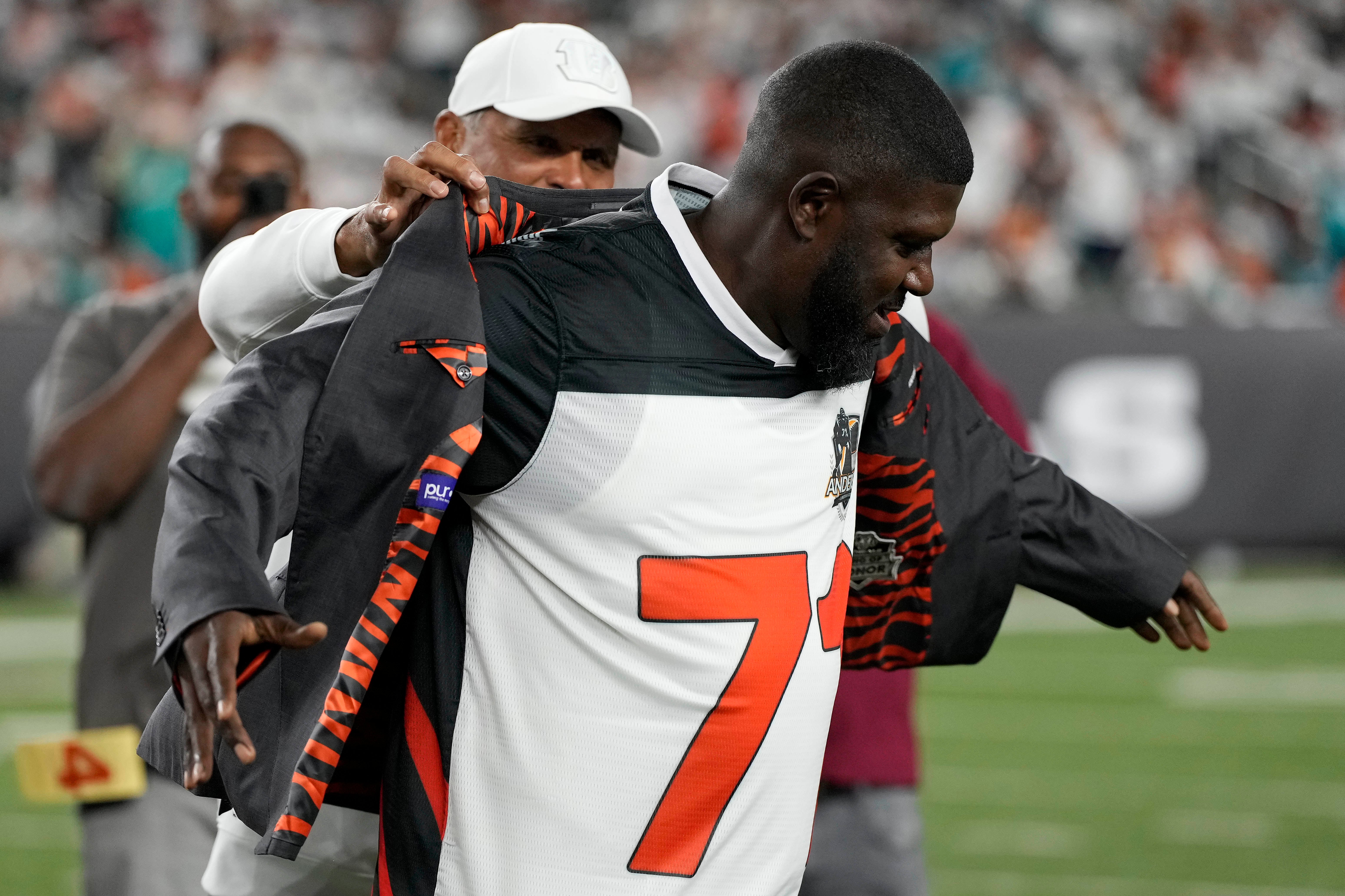 Sep 29, 2022; Cincinnati, Ohio, USA; Cincinnati Bengals former tackle Anthony Munoz puts the Ring of Honor jacket on new inductee Willie Anderson during a halftime ceremony of the game between the Cincinnati Bengals and the Miami Dolphins at Paycor Stadium.