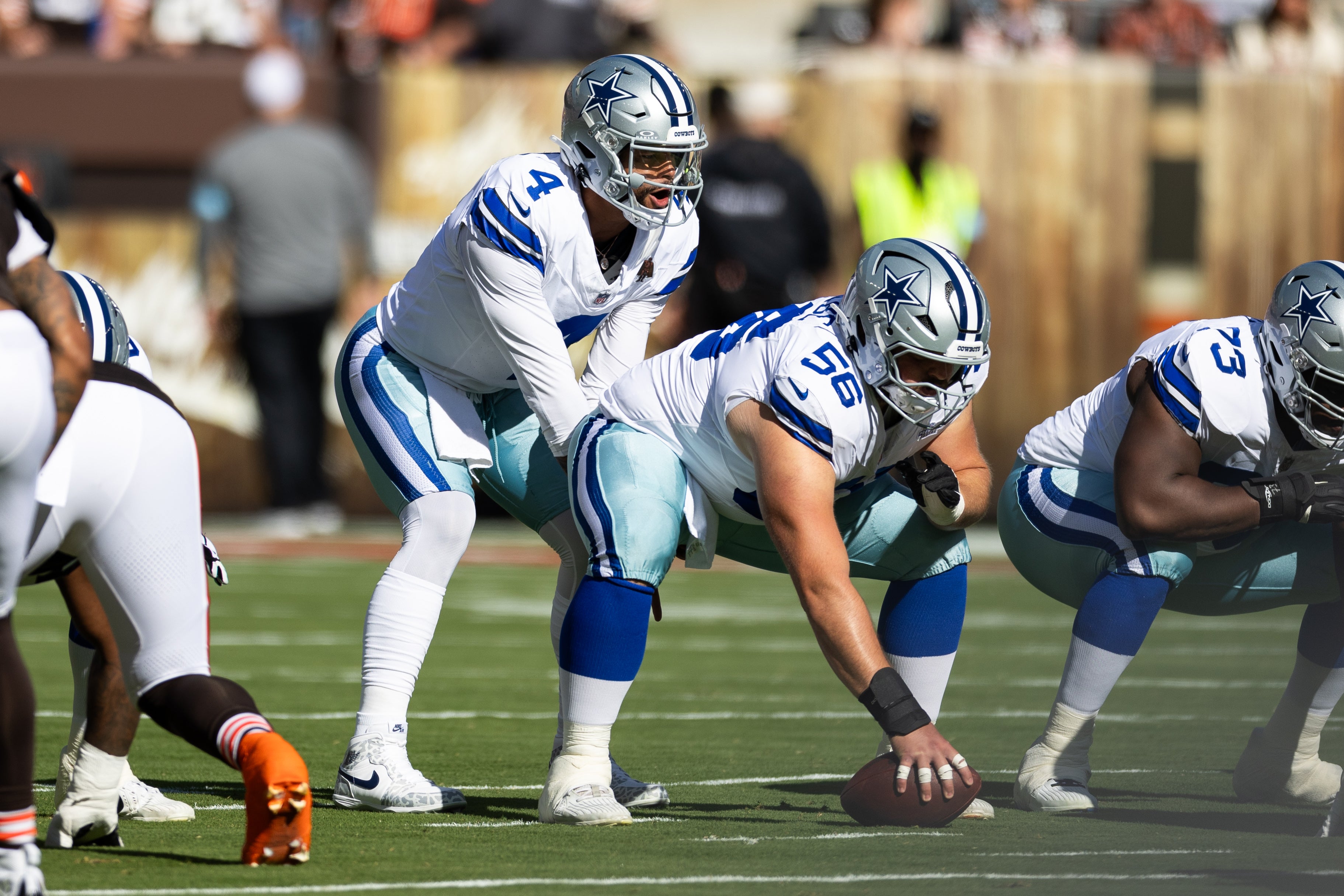 Dallas Cowboys quarterback Dak Prescott (4) lines up behind center Cooper Beebe (56) for the snap during the first quarter against the Cleveland Browns at Huntington Bank Field.