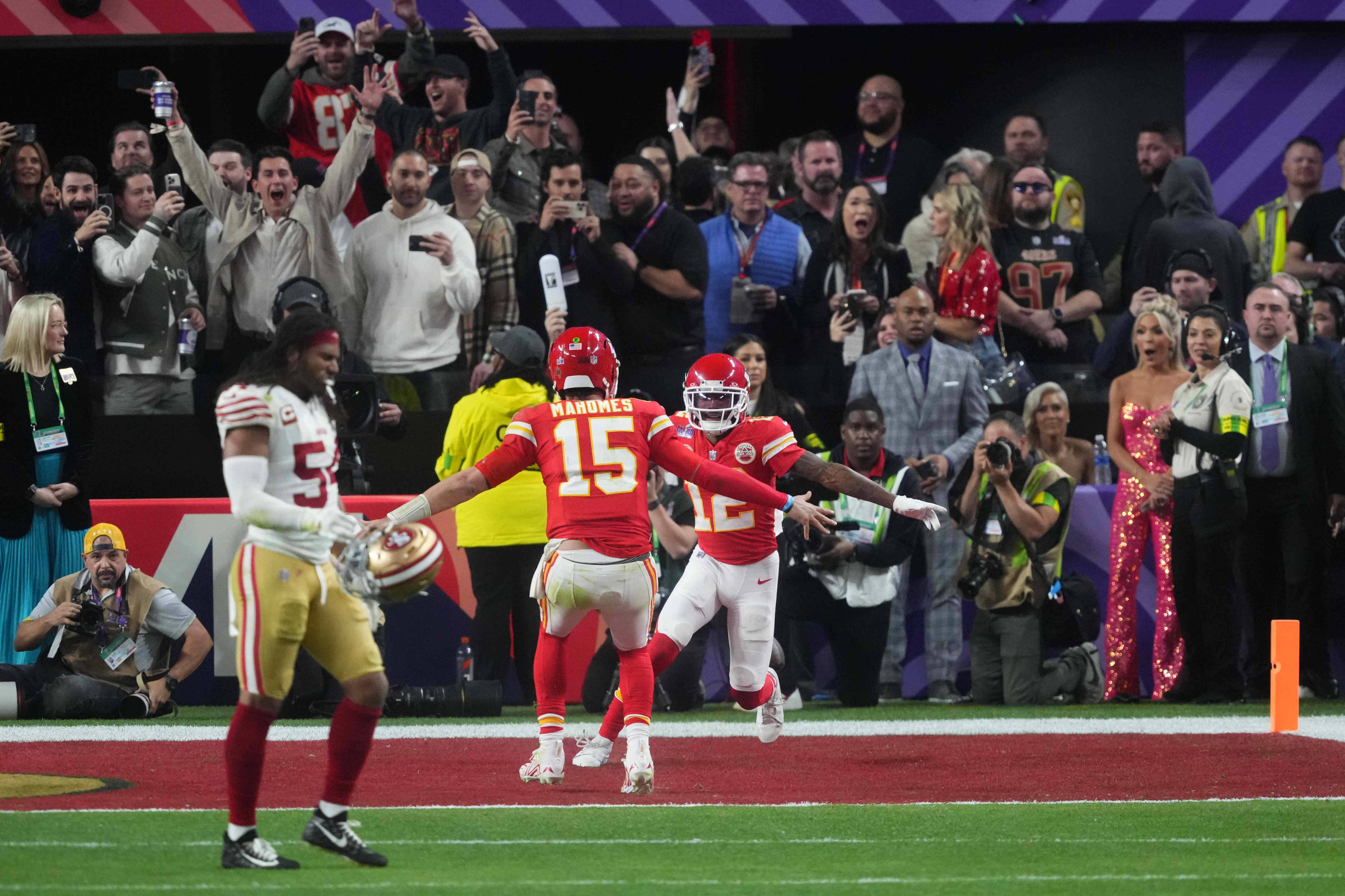 Feb 11, 2024; Paradise, Nevada, USA; Kansas City Chiefs wide receiver Mecole Hardman Jr. (12) celebrates his touchdown with quarterback Patrick Mahomes (15) to win in overtime against the San Francisco 49ers of Super Bowl LVIII at Allegiant Stadium.