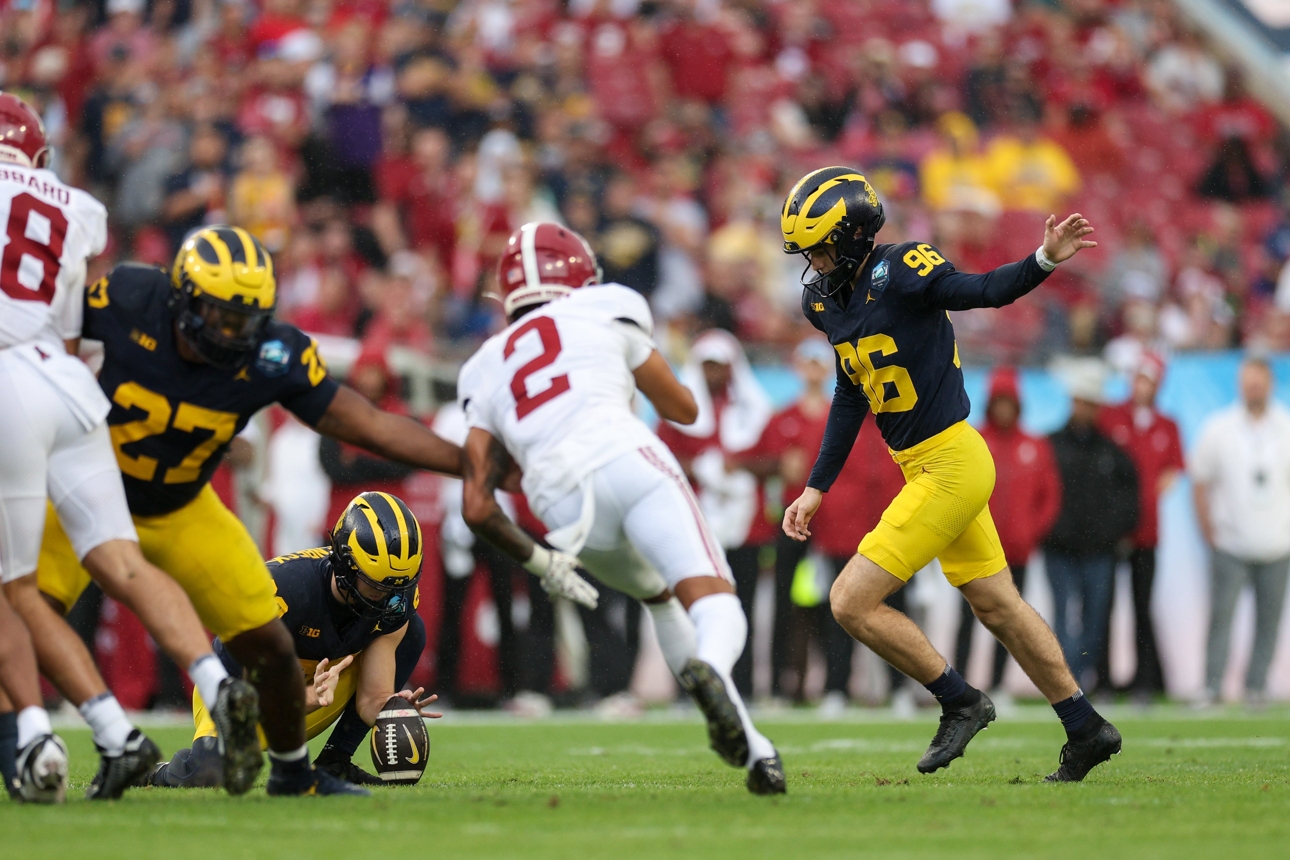 Dec 31, 2024; Tampa, FL, USA; Michigan Wolverines place kicker Dominic Zvada (96) kicks a field goal against the Alabama Crimson Tide in the first quarter during the ReliaQuest Bowl at Raymond James Stadium.