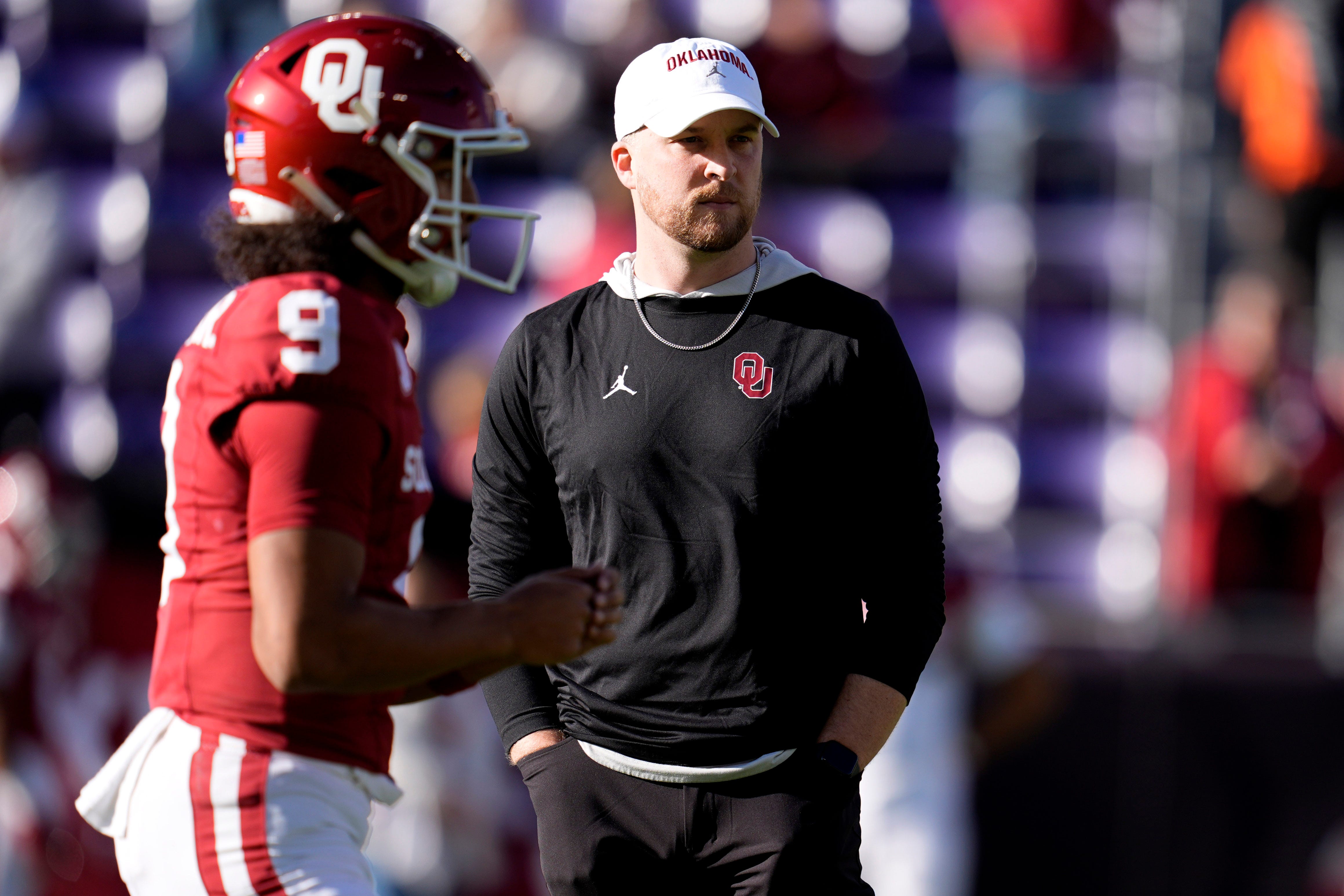Ben Arbuckle stands beside Oklahoma Sooners quarterback Michael Hawkins Jr. (9) before the Armed Forces Bowl football game between the University of Oklahoma Sooners (OU) and the Navy Midshipmen at Amon G. Carter Stadium in Fort Worth, Texas, Friday, Dec. 27, 2024.