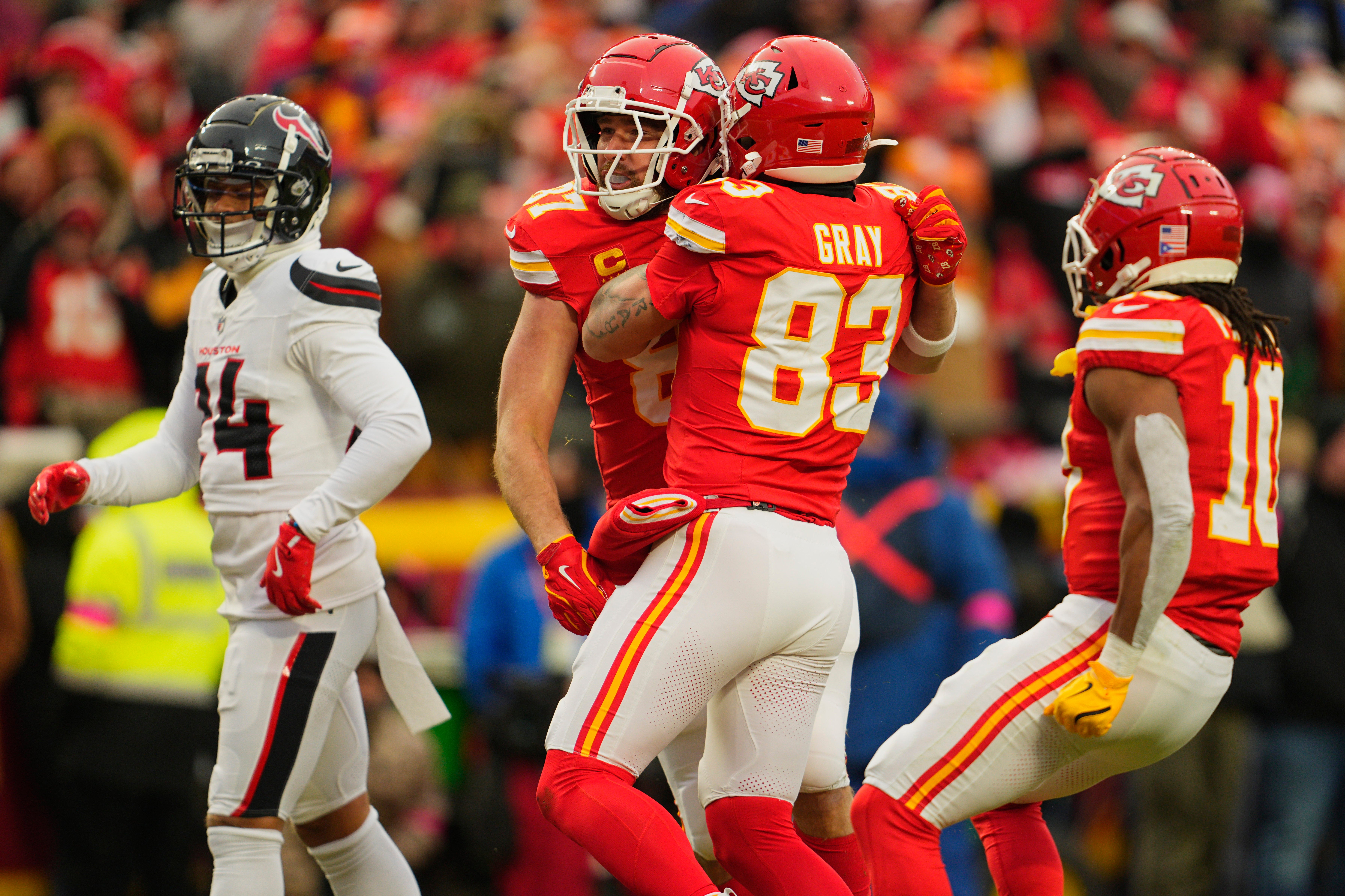 Jan 18, 2025; Kansas City, Missouri, USA; Kansas City Chiefs tight end Travis Kelce (87) celebrates with tight end Noah Gray (83) after making a long pass reception against the Houston Texans during the second quarter of a 2025 AFC divisional round game at GEHA Field at Arrowhead Stadium.