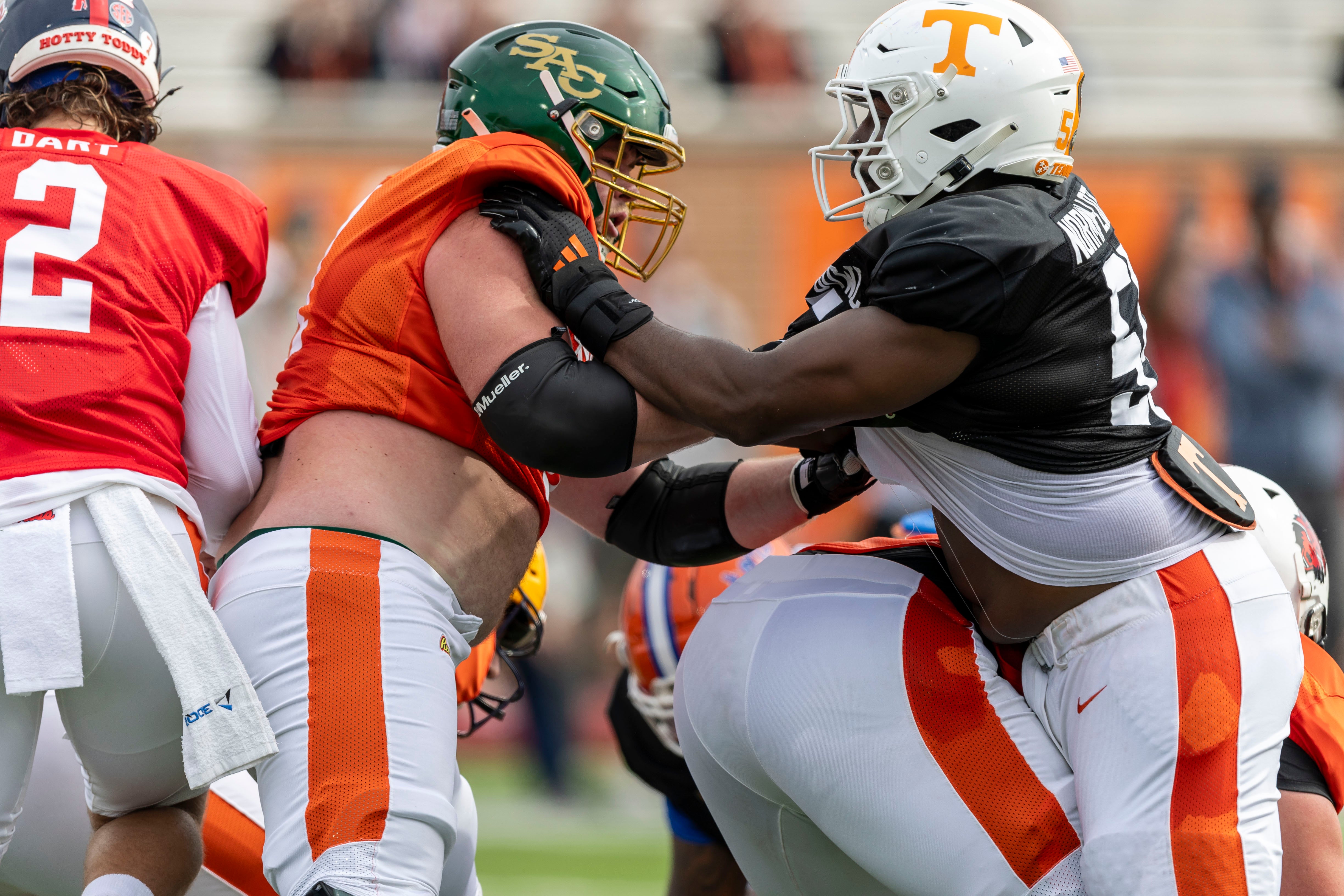 Jan 28, 2025; Mobile, AL, USA; American team offensive lineman Jackson Slater of Sacramento State (67) battles with American team defensive lineman Omarr Norman-Lott of Tennessee (55) during Senior Bowl practice for the American team at Hancock Whitney Stadium.