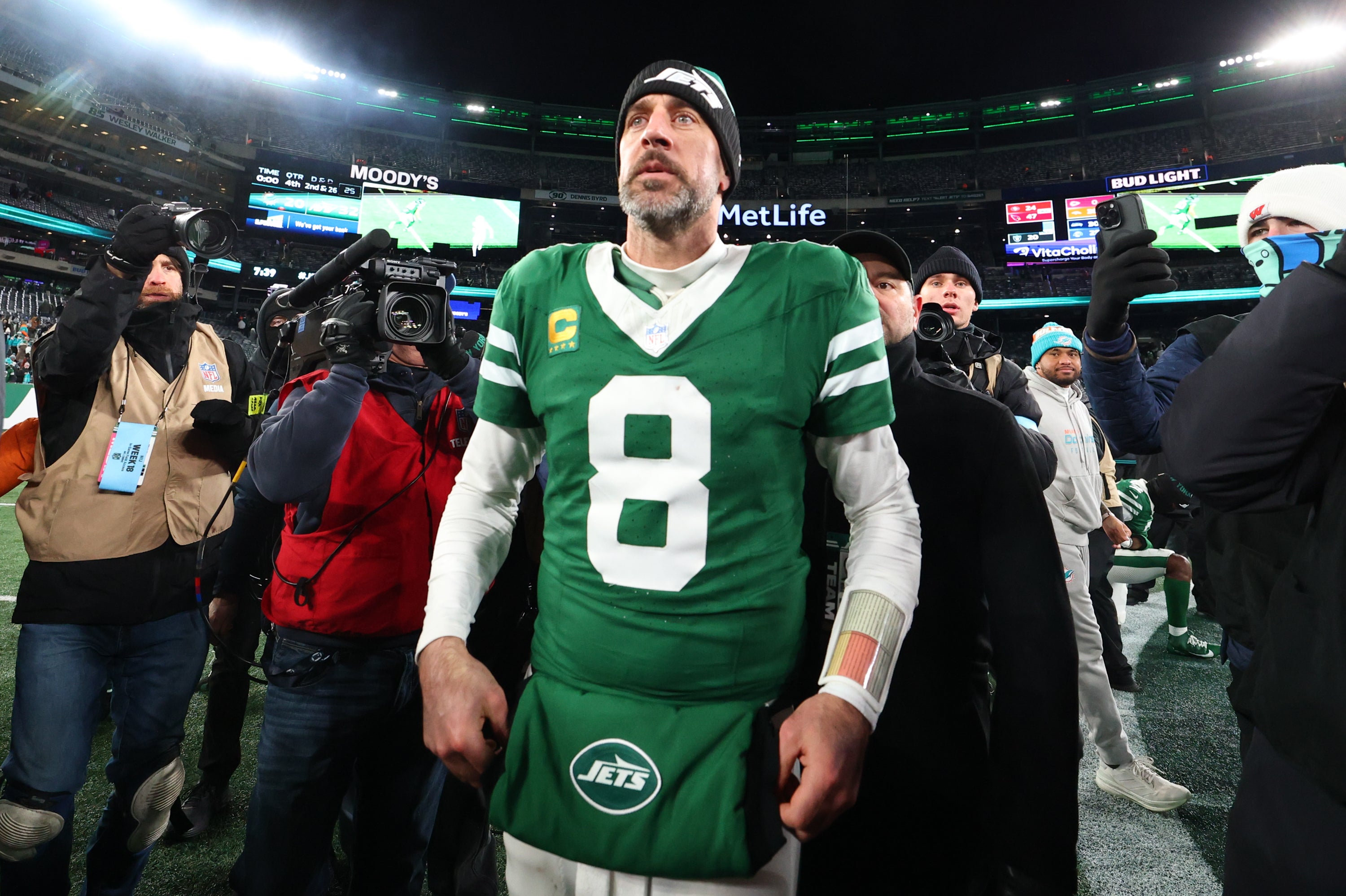 New York Jets quarterback Aaron Rodgers (8) walks on the field after the Jets win over the Miami Dolphins at MetLife Stadium.