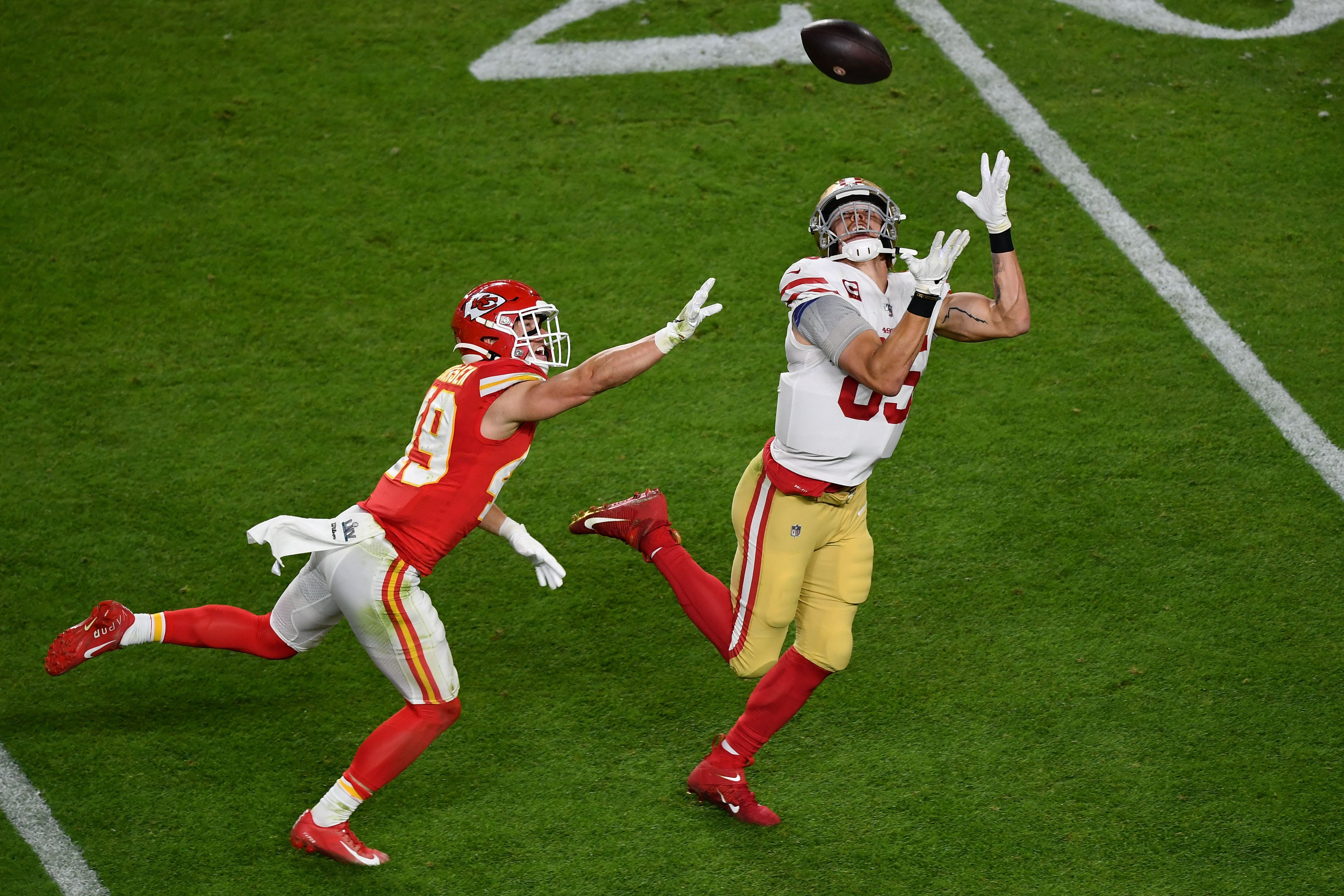 San Francisco 49ers tight end George Kittle (85) makes a reception which is called back for offensive pass interference on Kansas City Chiefs defensive back Daniel Sorensen (49) during the second quarter in Super Bowl LIV at Hard Rock Stadium.